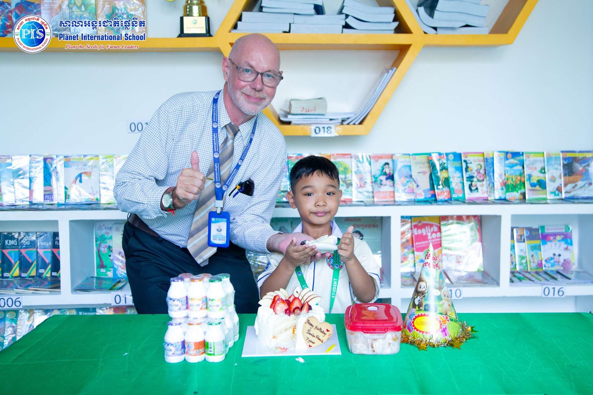 Teacher and student smiling together during birthday celebration at Chbar Ampov Campus