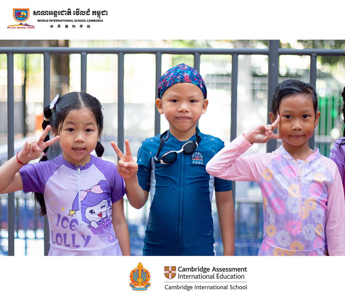 Young students from World International School Cambodia pose confidently in their swimwear, celebrating their early swimming class experience.