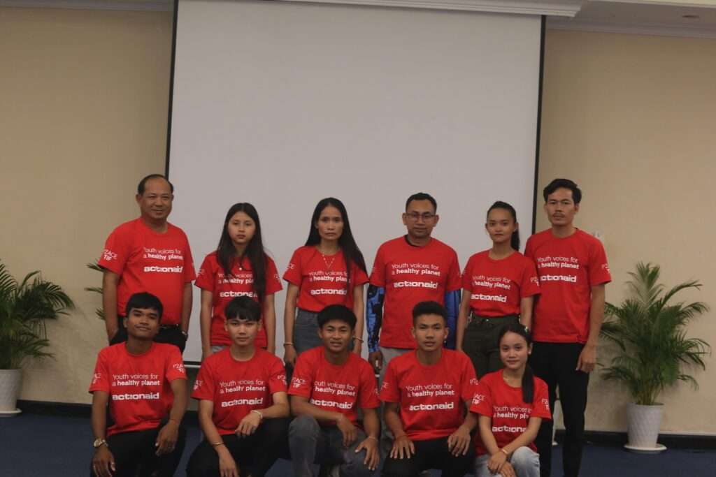 Youth leaders and staff of ActionAid Cambodia posing in red “Youth voices for a healthy planet” shirts during an advocacy workshop in Phnom Penh.