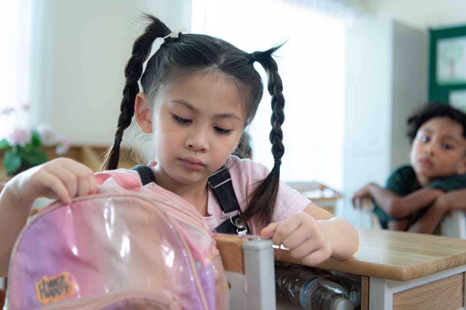 Child receiving autism therapy in Phnom Penh classroom, focusing on communication and sensory development