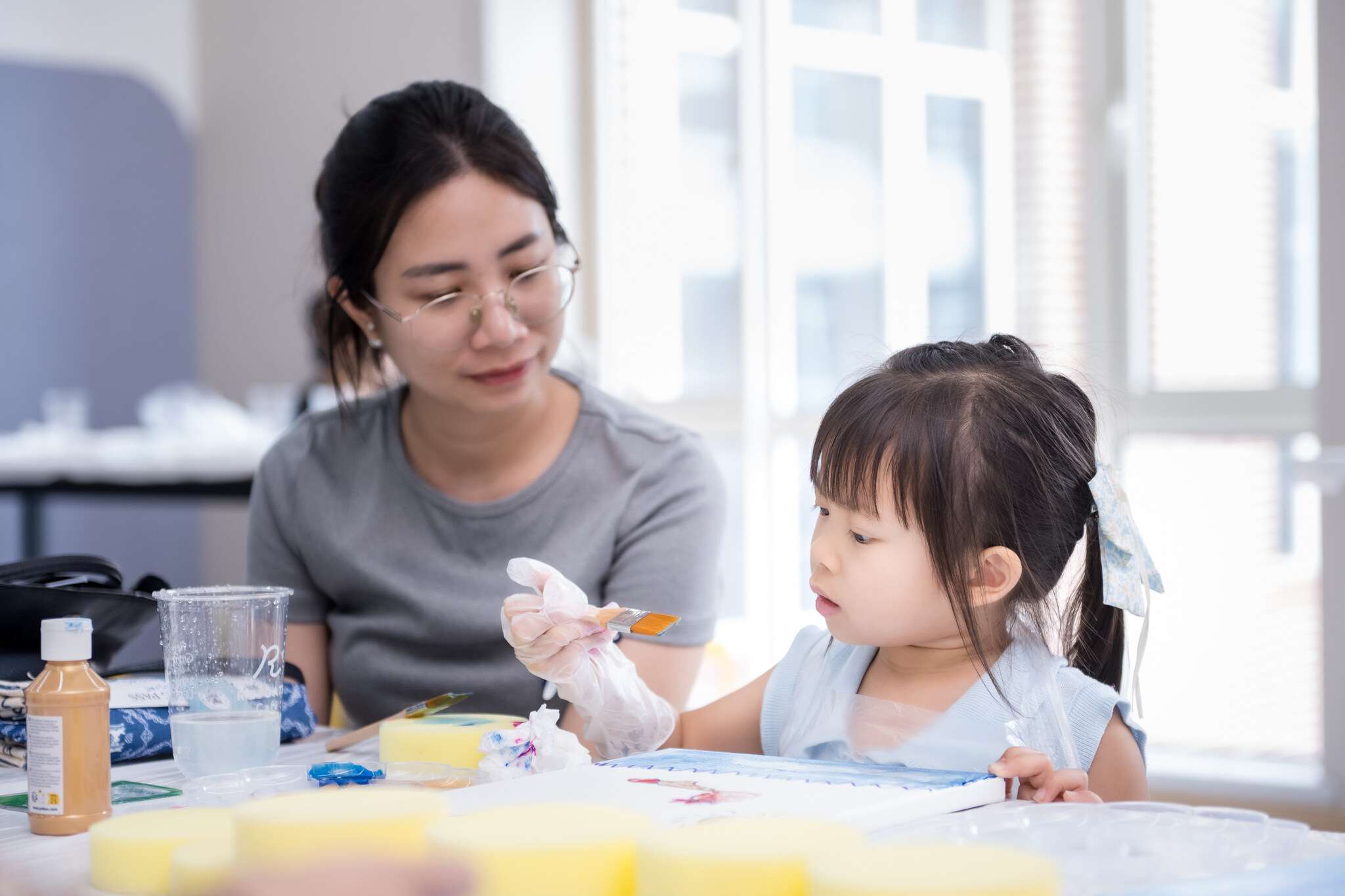 Teacher and child engaging in independent task at Reigate Grammar School Phnom Penh – promoting self-help and life skills