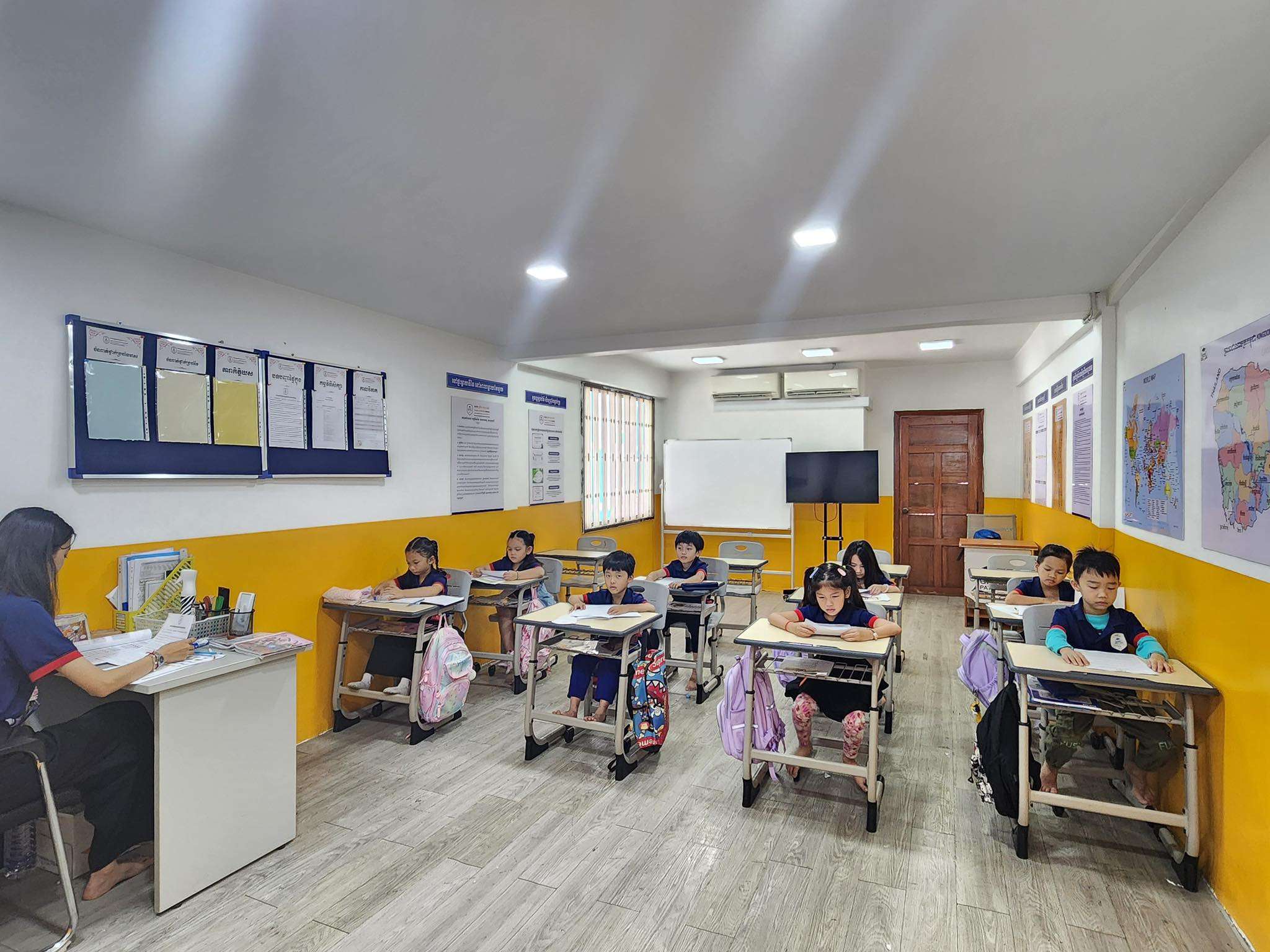 Primary school students at Global Pathways School Phnom Penh seated in a bright, colorful classroom during a structured lesson