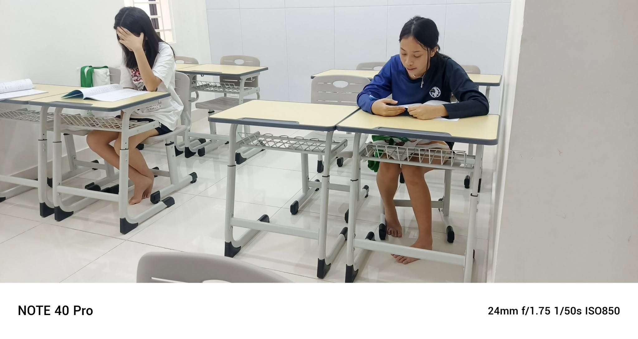 Two students at OAK Chinese Education in Phnom Penh sitting in class during a Mandarin lesson