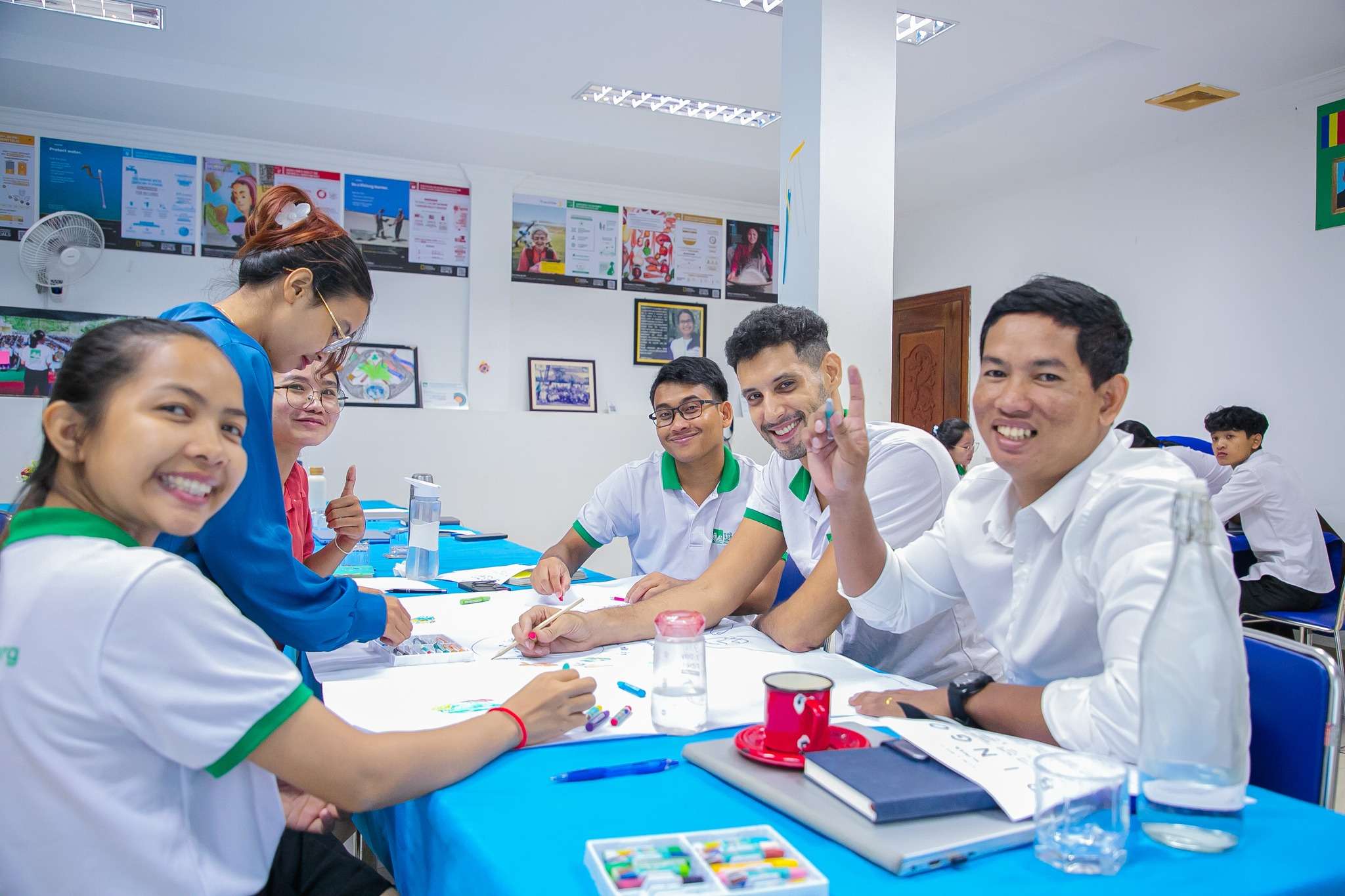 PEPY Empowering Youth Cambodia staff participating in a collaborative workshop with interactive group activities, led by Maire, to strengthen team communication and trust.