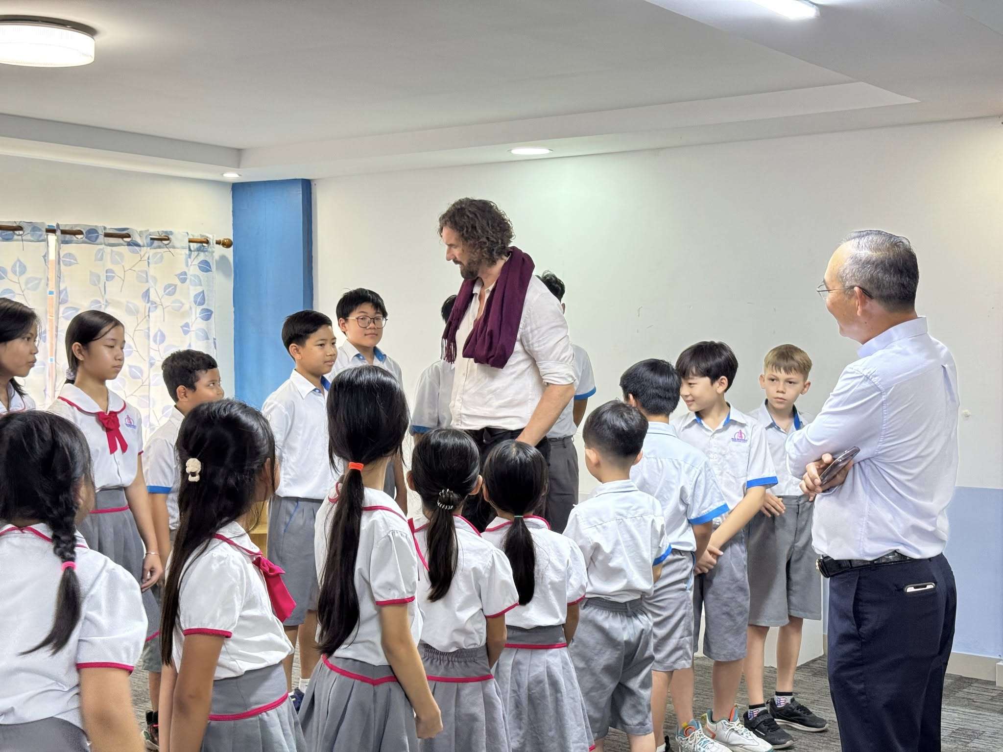 Phnom Penh Montessori students, Gavin McCormack, and government officials celebrating the completion of a 1,700-tree planting project with Upschool