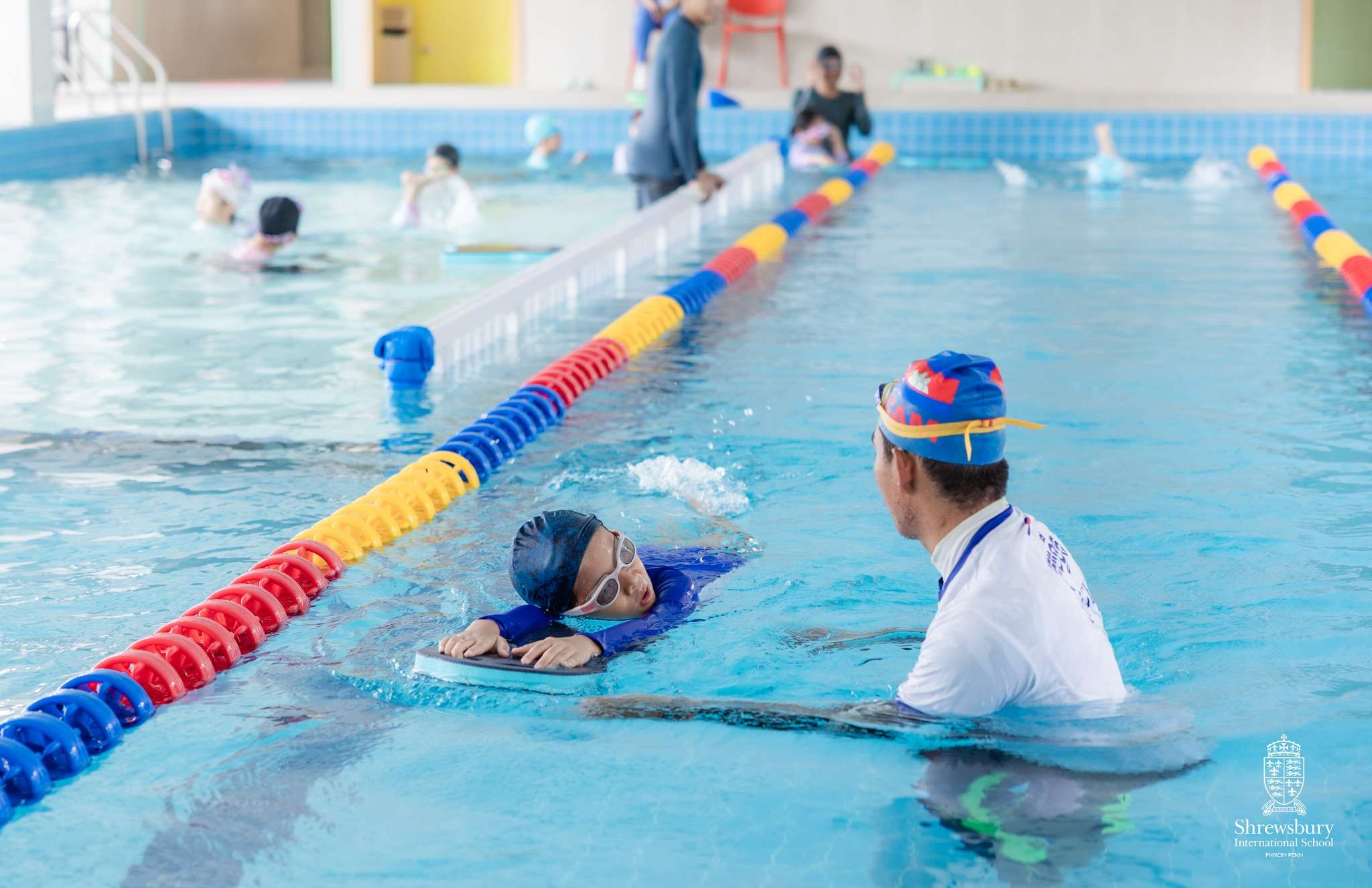 Children from Shrewsbury International School Phnom Penh enjoying summer camp activities including classroom fun and swimming, under staff supervision.