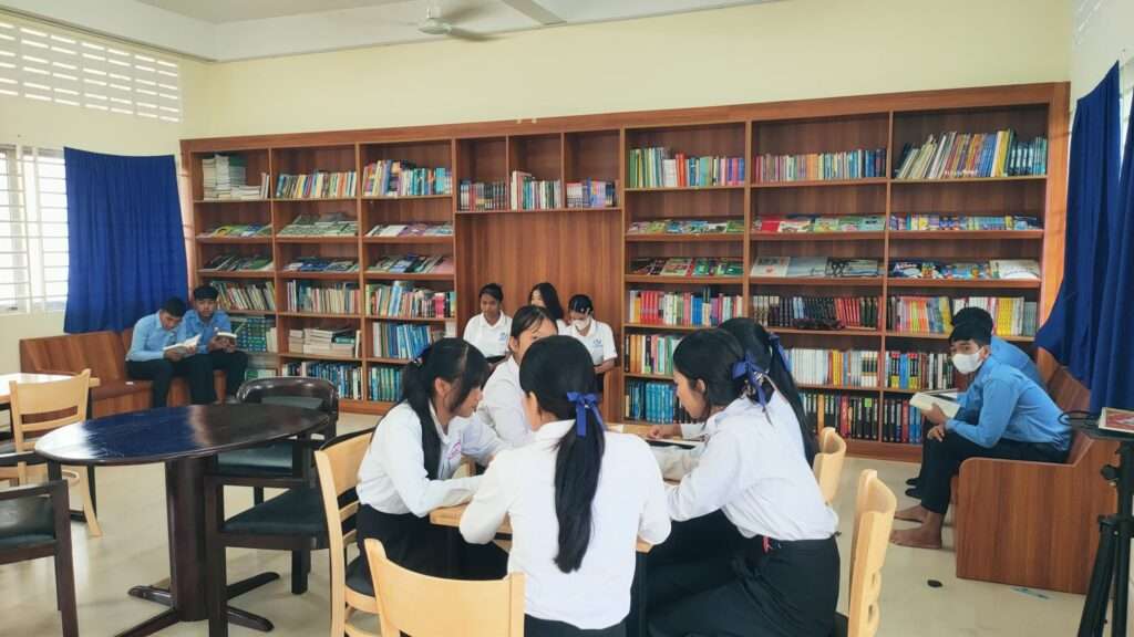 Students from Chakryavong High School engaging with books and professionals during Sipar Cambodia’s library setup and career forum event