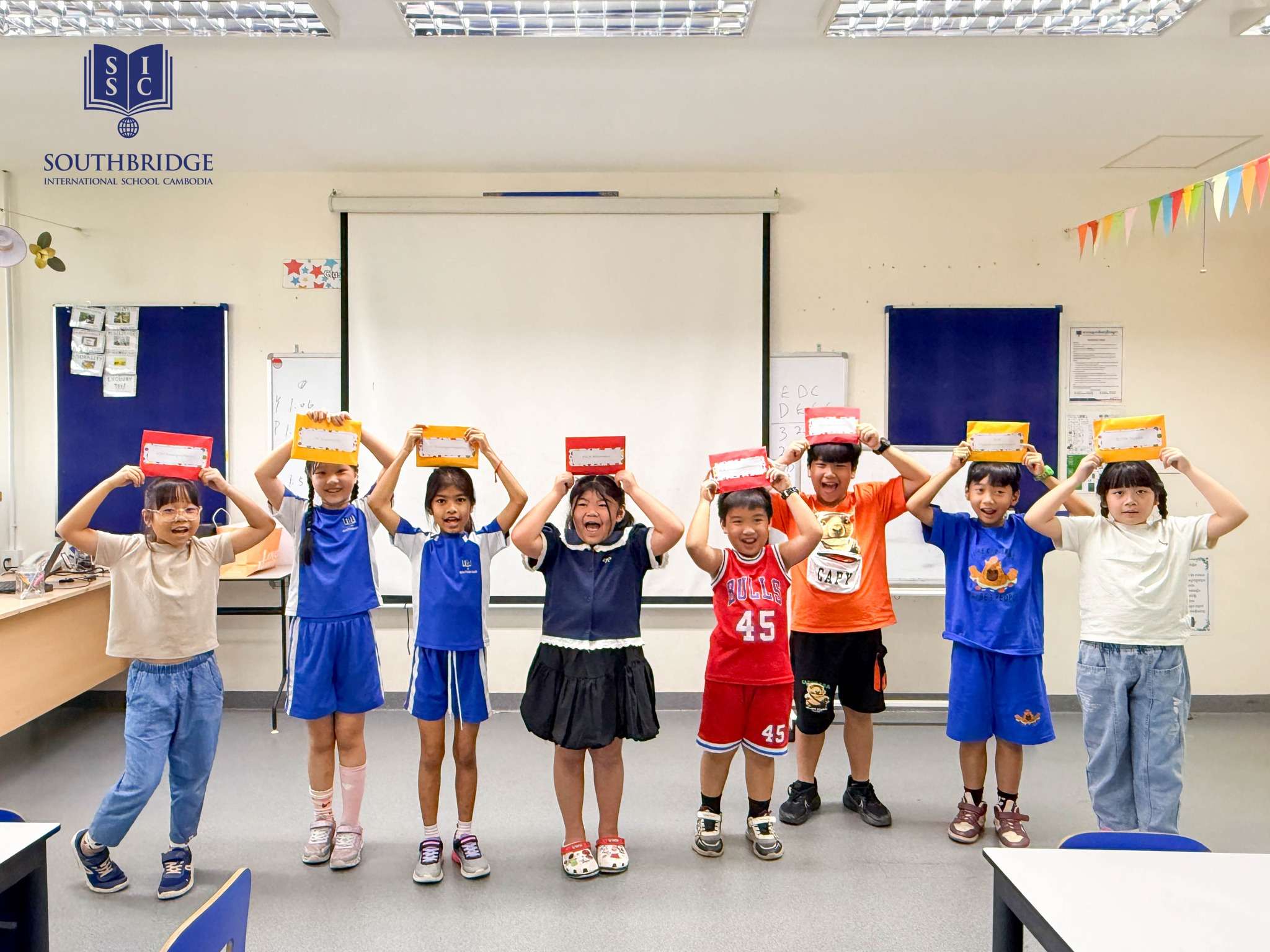 Students at Southbridge International School Cambodia participating in summer school activities including STEM, calligraphy, and physical challenges
