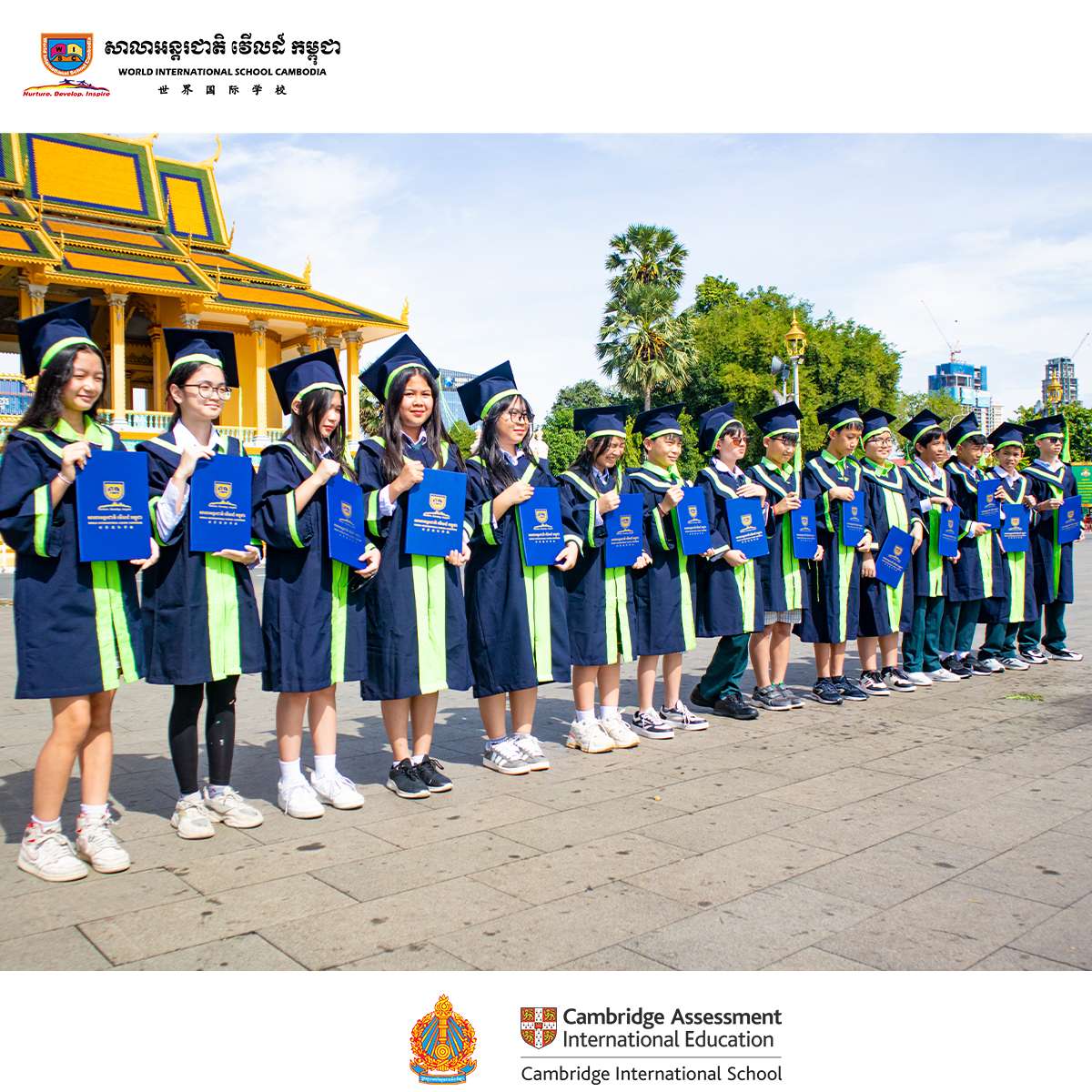 Students from World International School Cambodia proudly pose in graduation gowns during their ceremony, holding certificates and smiling