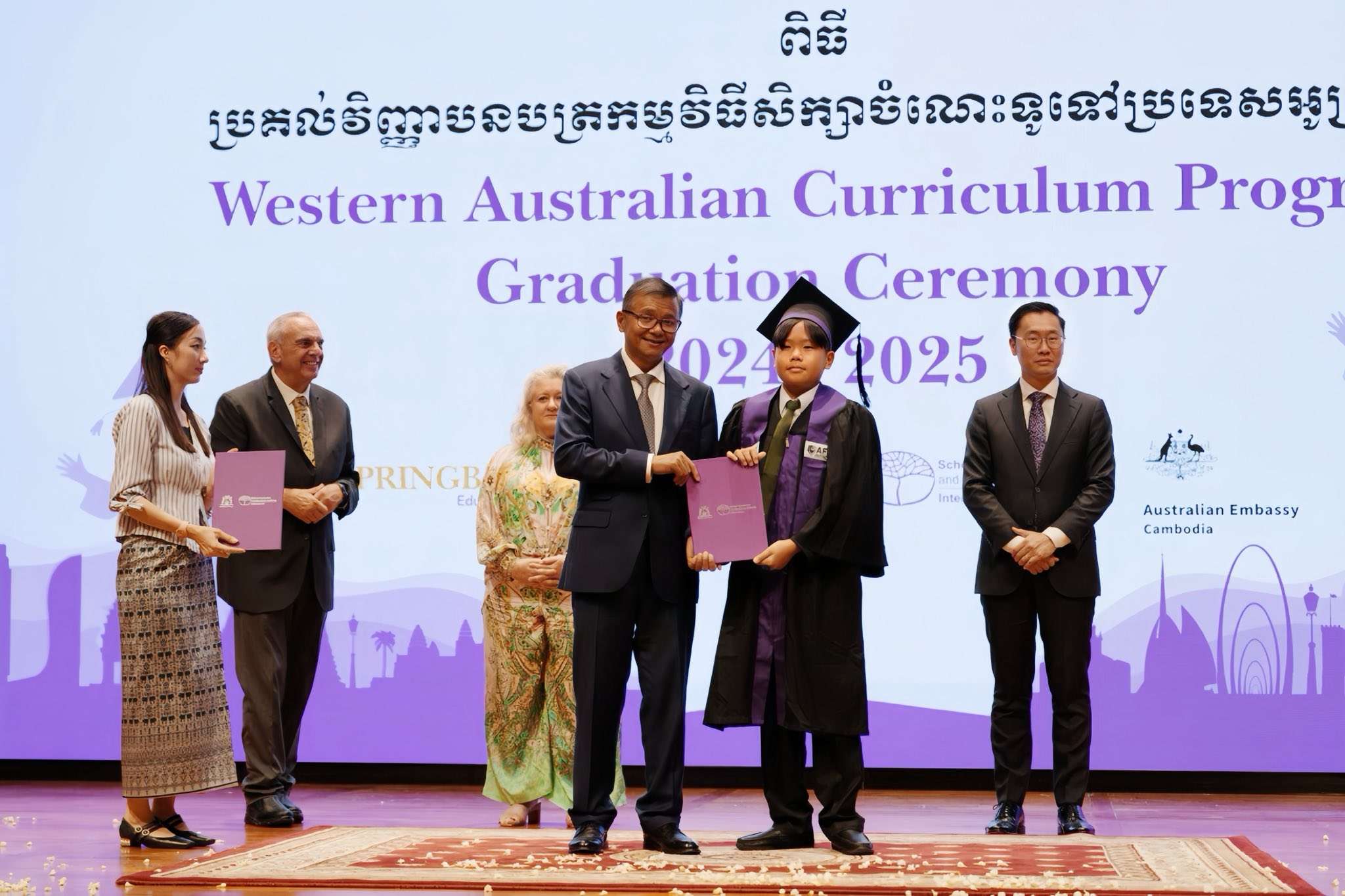 AFIS graduation ceremony with students receiving diplomas and certificates, celebrating achievements under the Western Australian Curriculum in Phnom Penh.