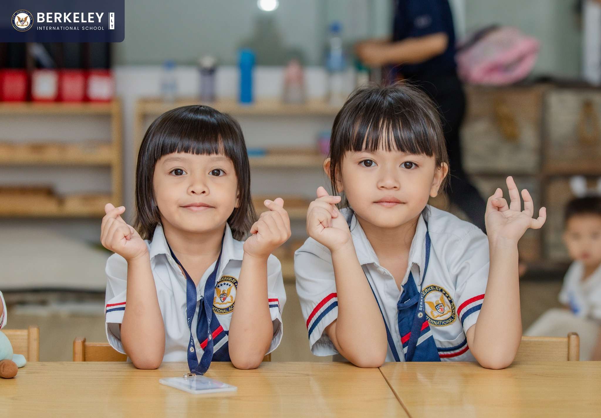 Children raising hands in class at Berkeley International School