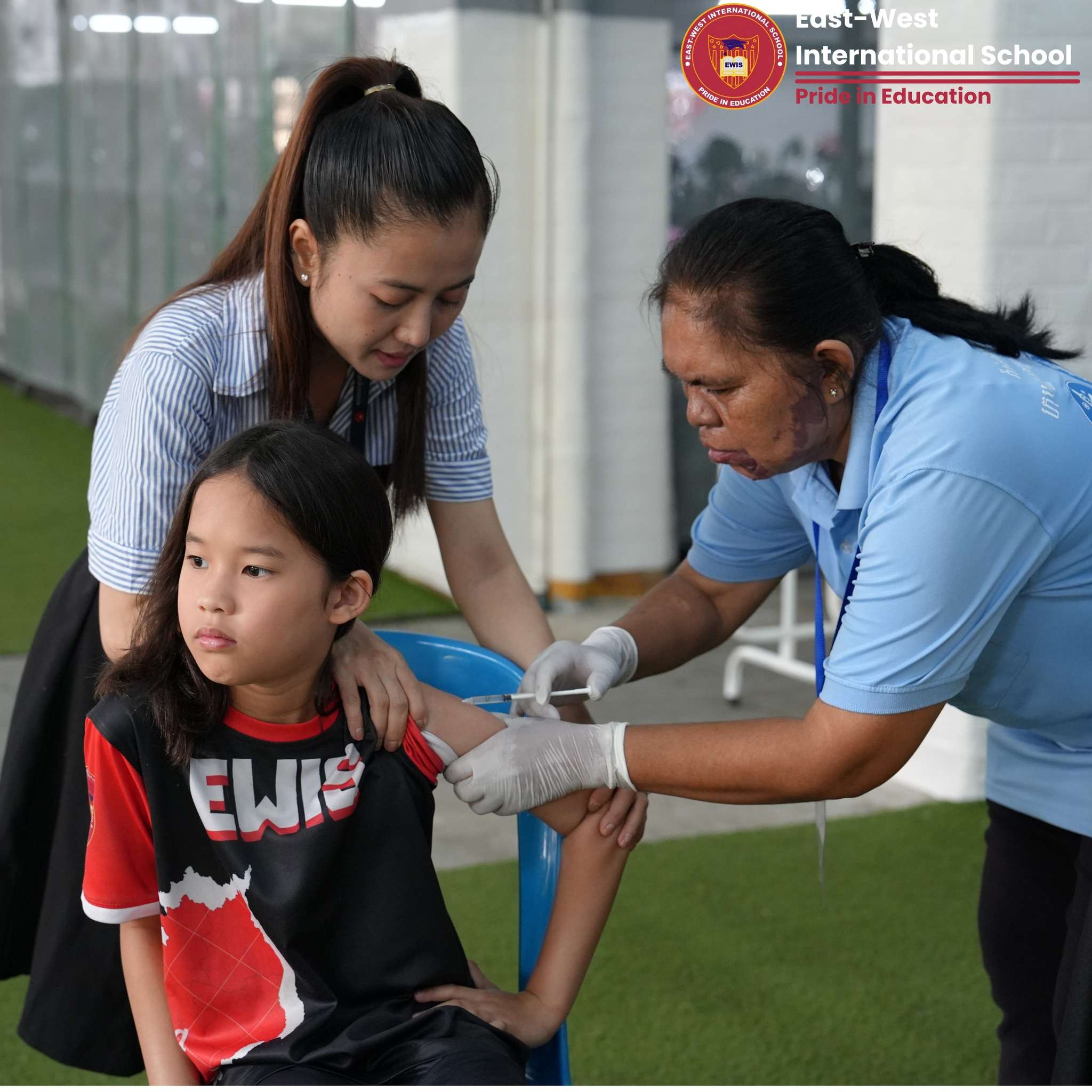 East-West International School Cambodia students receiving Measles and Rubella booster vaccinations on campus with support from health professionals and school staff.
