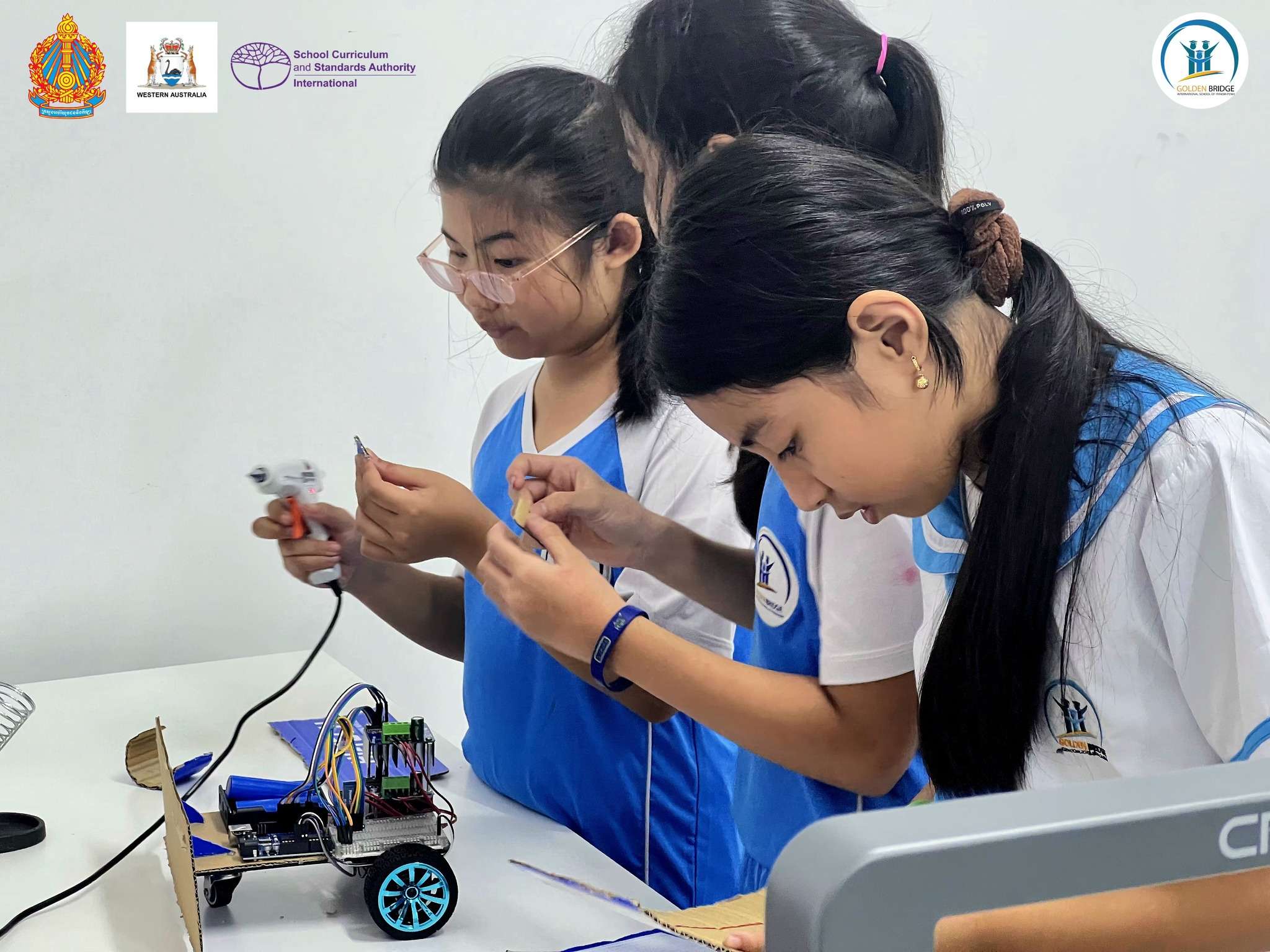Golden Bridge International School Phnom Penh students participating in robotics lessons, assembling and programming MicroBot PCB boards in a STEM classroom