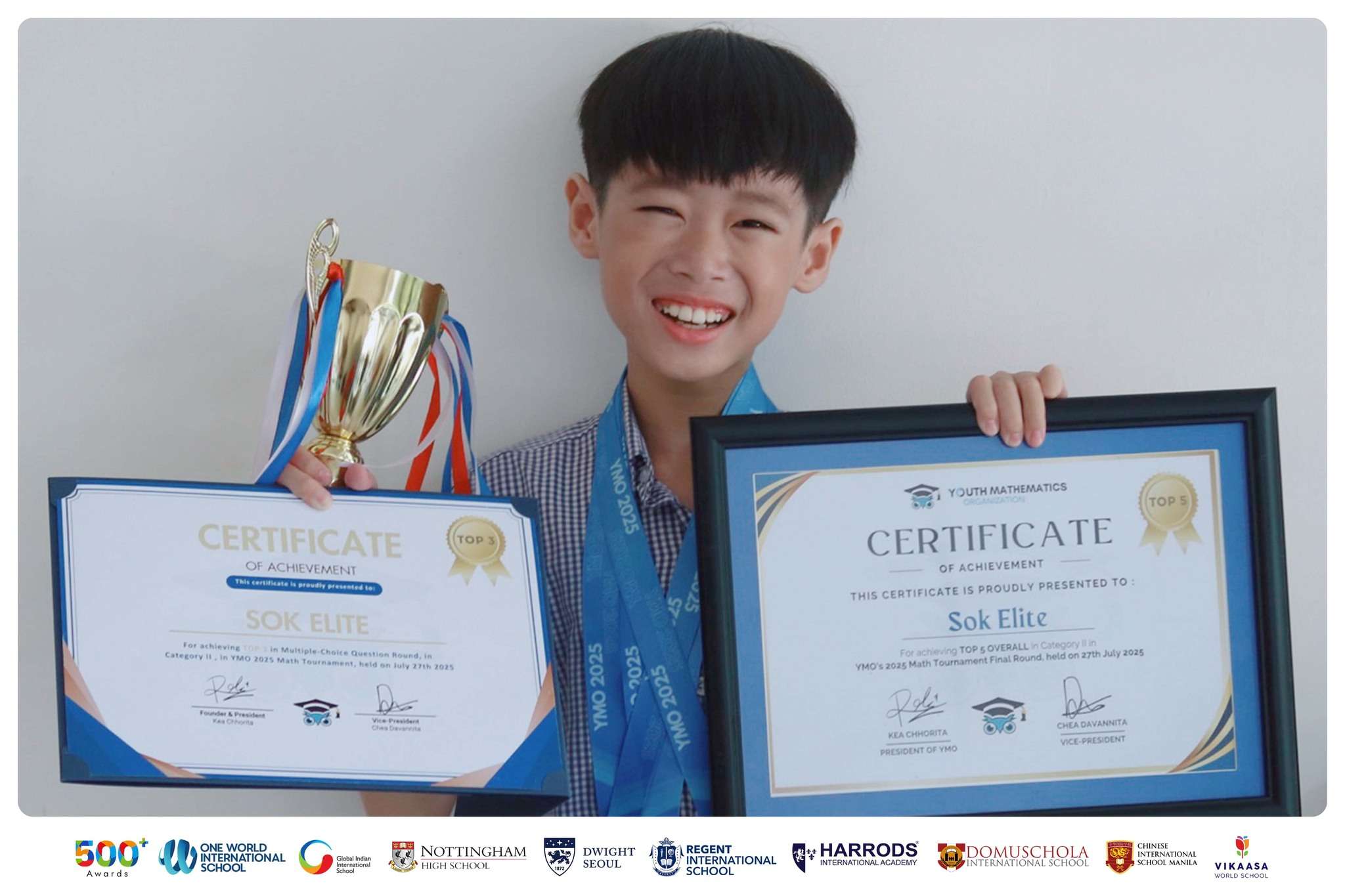 Student Sok Elite proudly holding a trophy at Harrods International Academy.