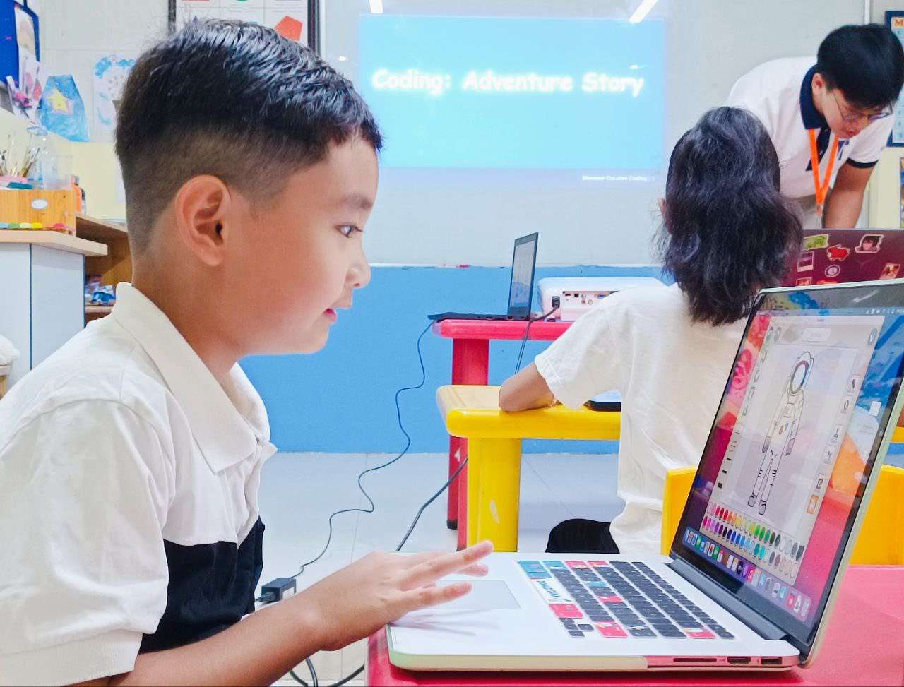 Students at Phnom Penh Montessori International School engaged in summer program activities, including AI and Robotics projects, using laptops and tablets.