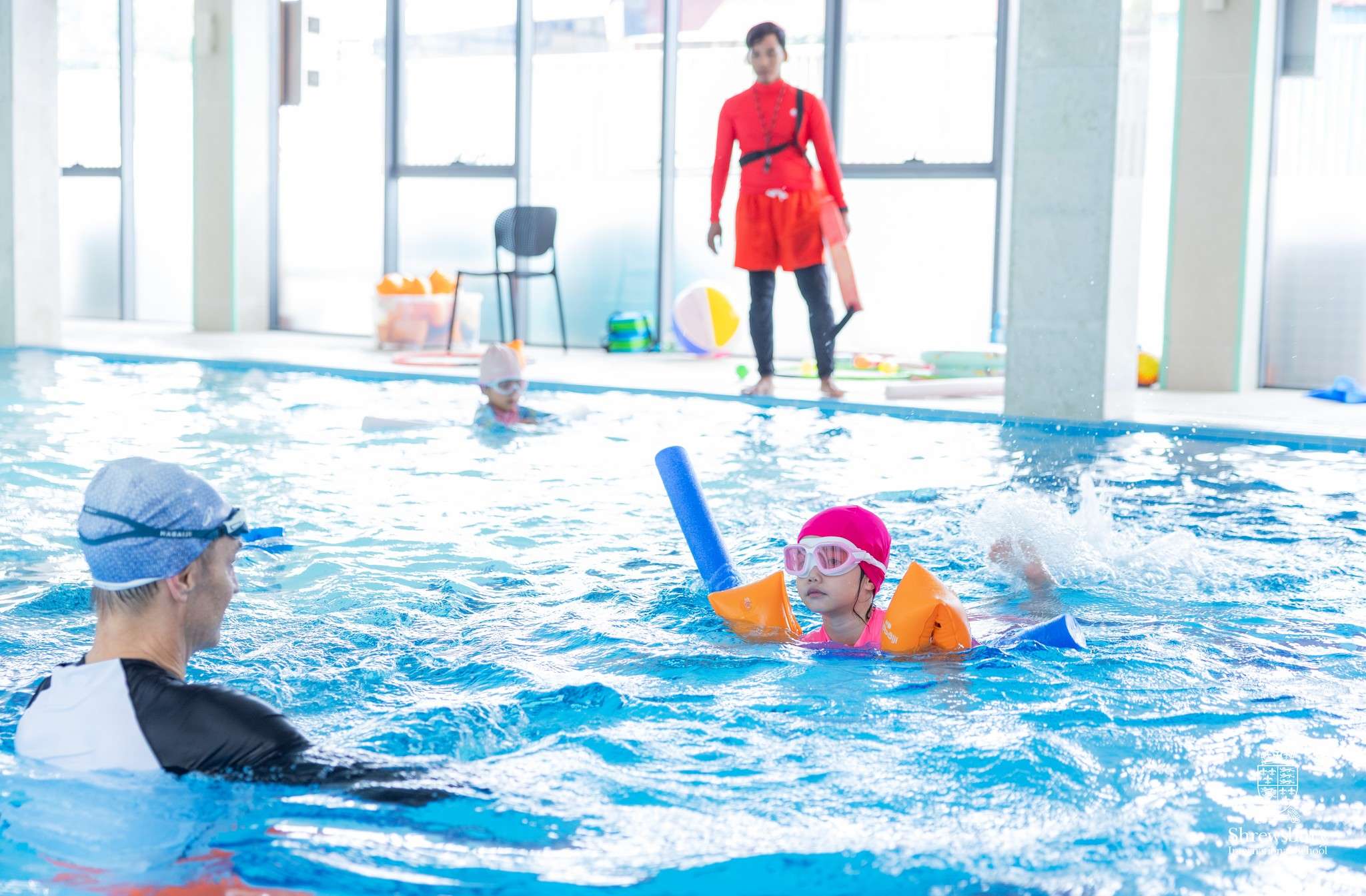 Children enjoying Saturday School activities at Shrewsbury International School Phnom Penh, including swimming, LEGO robotics, and music learning.