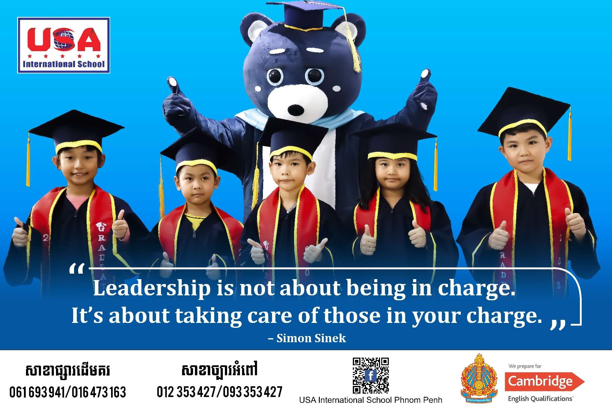 Students of USA International School Phnom Penh wearing graduation gowns and posing with the school mascot, promoting leadership and education in Cambodia.