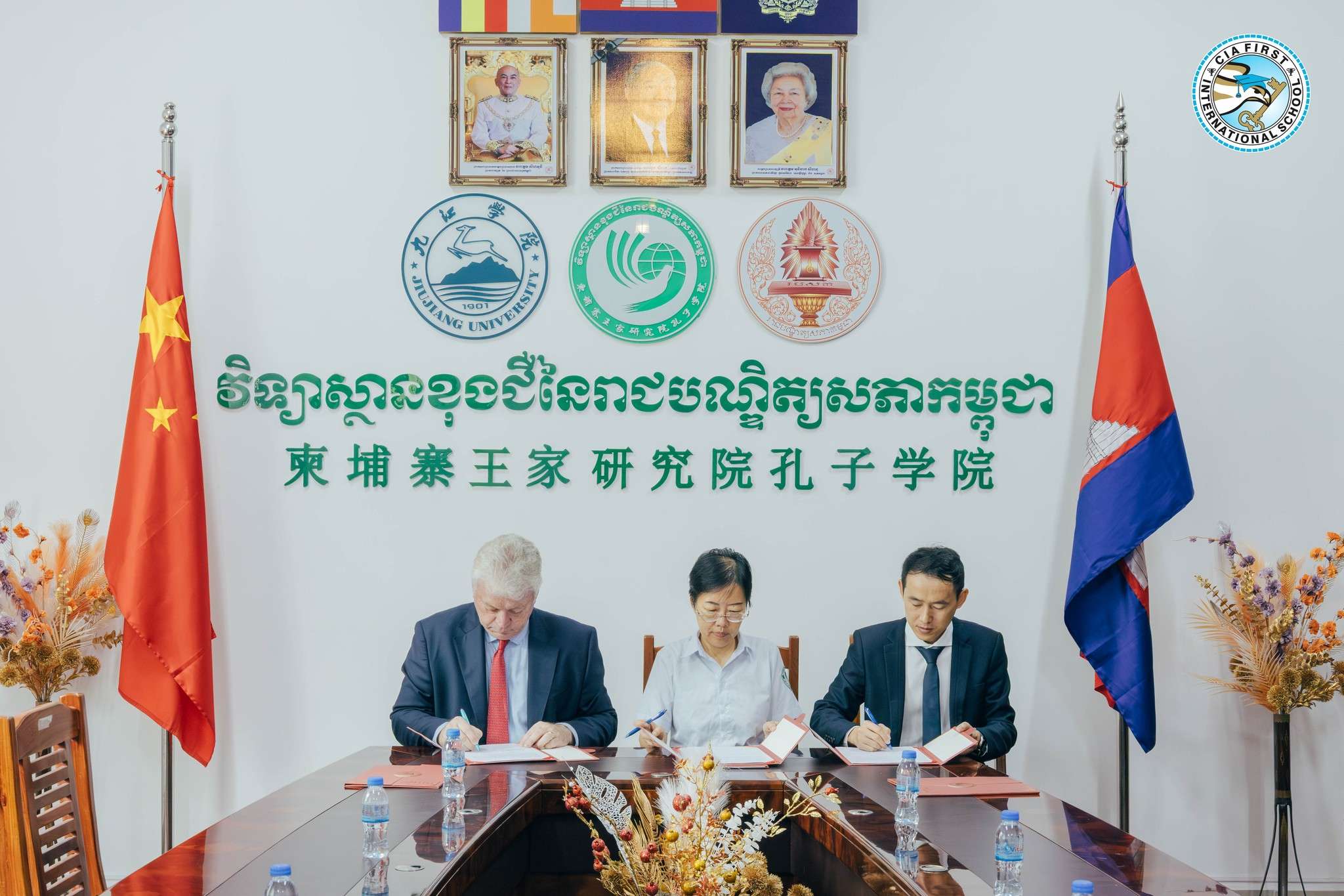 Mr. Michael Wilde and Confucius Institute directors holding signed MoU documents at the ceremony