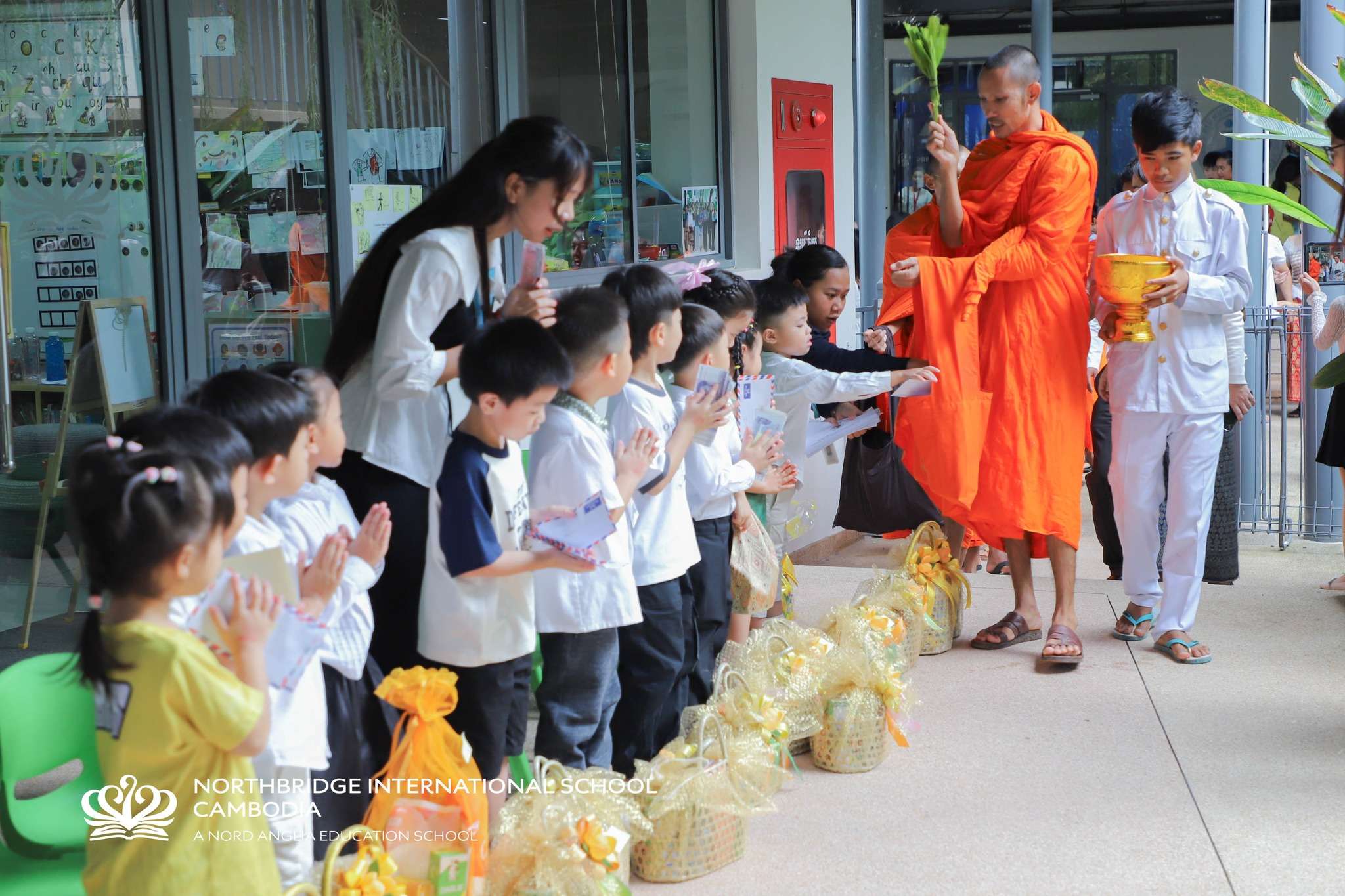 Students and monks participating in Pchum Ben blessing ceremony at Northbridge International School Cambodia