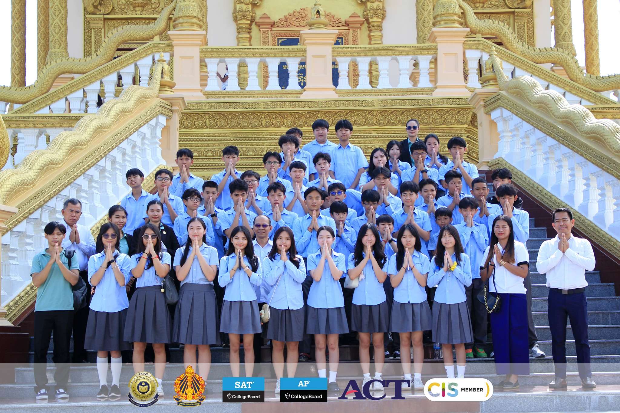 Students of Golden Gate American School in uniform participating in a cultural ceremony at a Cambodian pagoda.