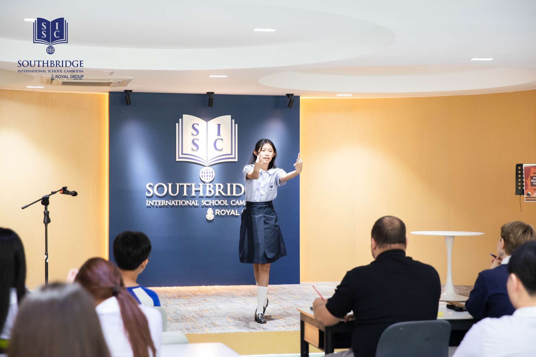 Students performing on stage during the Poetry Recitation Contest at Southbridge International School Cambodia as part of Literacy Week celebrations.