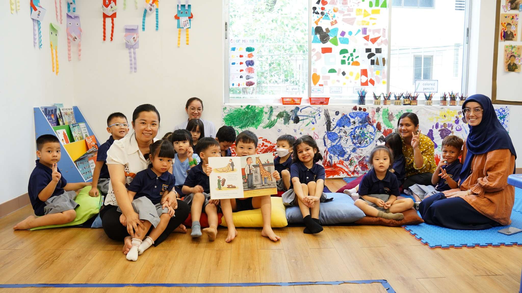 Children and parents at Invictus International School Phnom Penh participating in the Early Years Literacy Project, enjoying storytime together in the classroom.