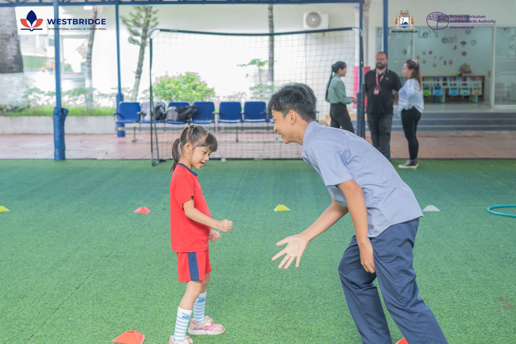 Students at Westbridge International School of Phnom Penh enjoying morning assembly activities through play, movement, and teamwork.