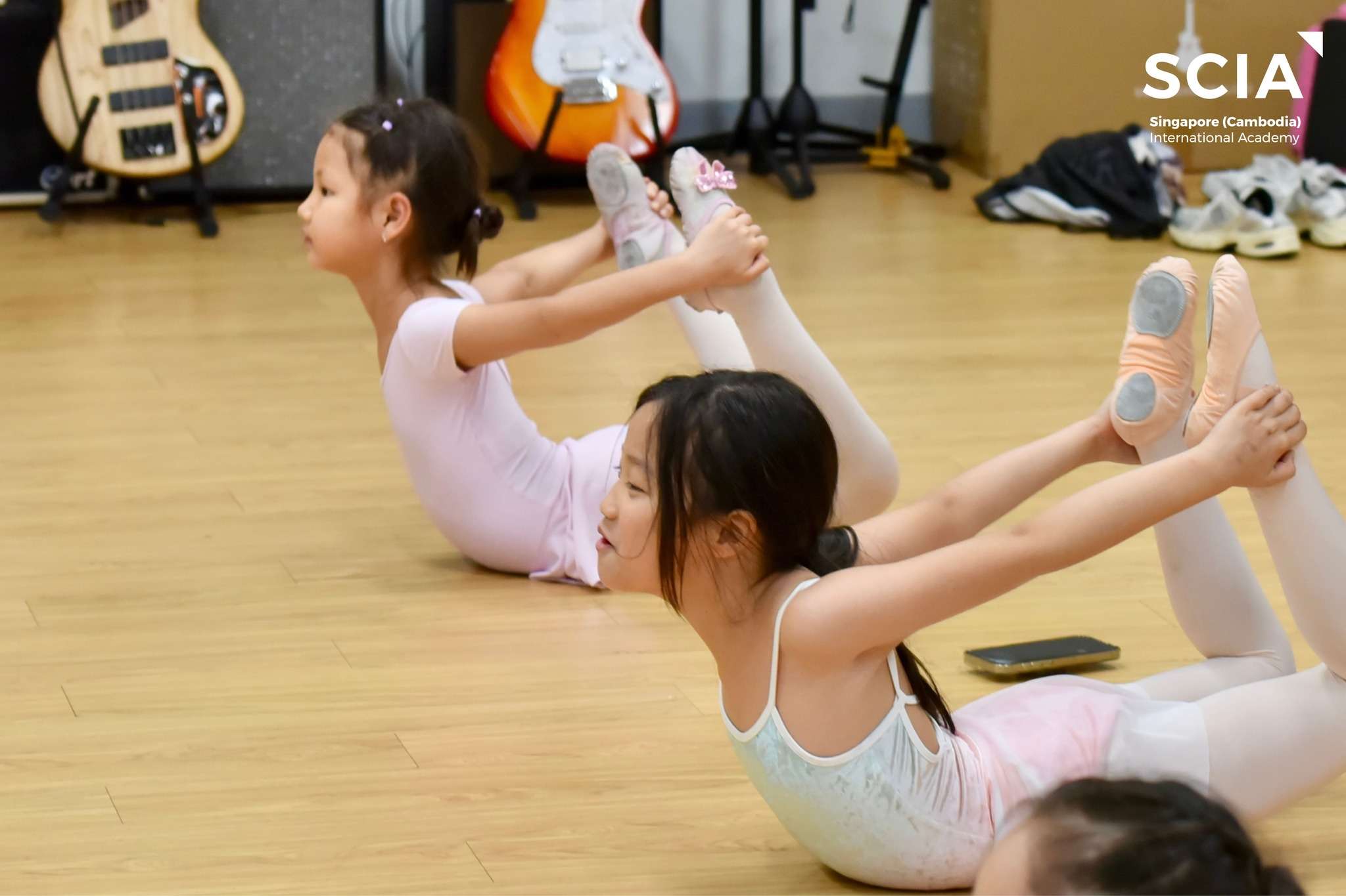 Students at Singapore Cambodia International Academy participating in extra-curricular activities including sports, arts, and teamwork exercises.