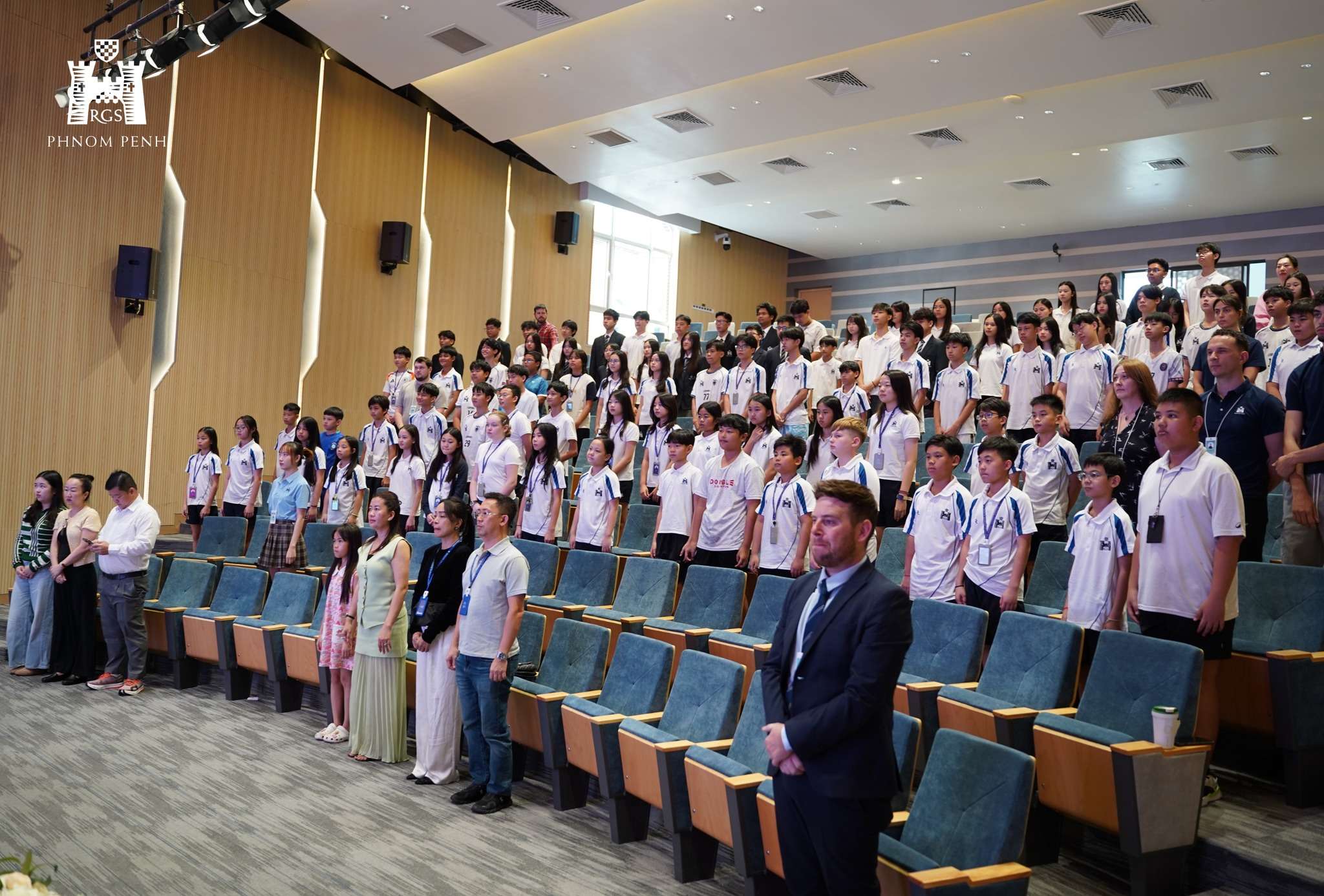 Students and speakers participating in King’s Coronation Day celebration at Reigate Grammar School Phnom Penh