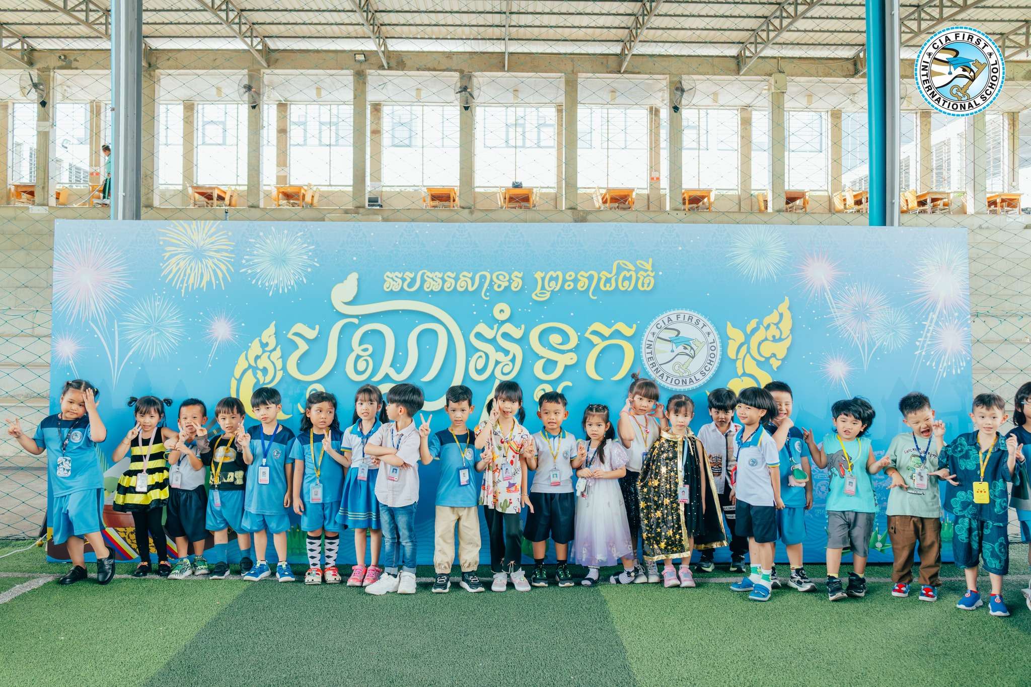Students and teachers gathered under a decorated backdrop celebrating the Water Festival at CIA FIRST International School.