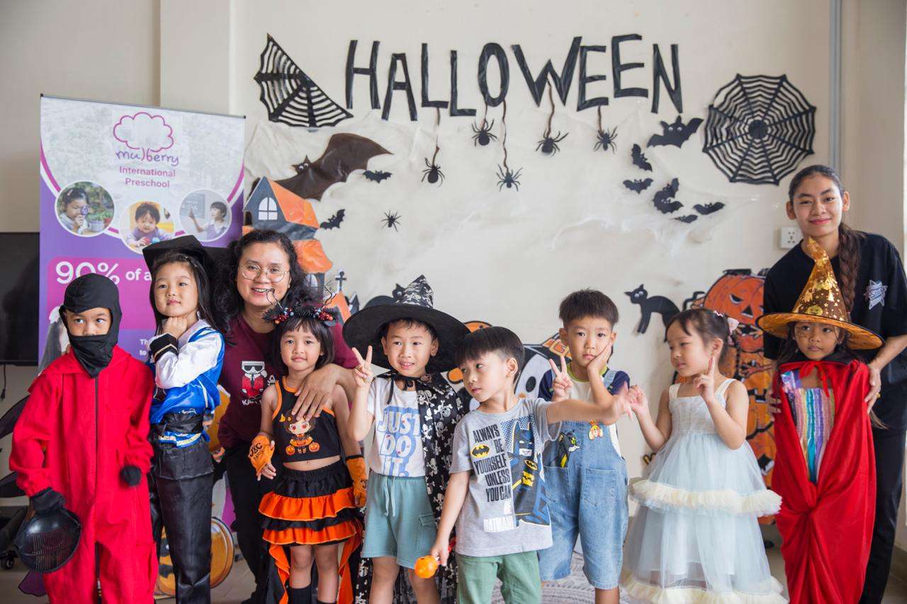 Children, teachers, and families joyfully celebrating Halloween with costumes at Mulberry International Preschool