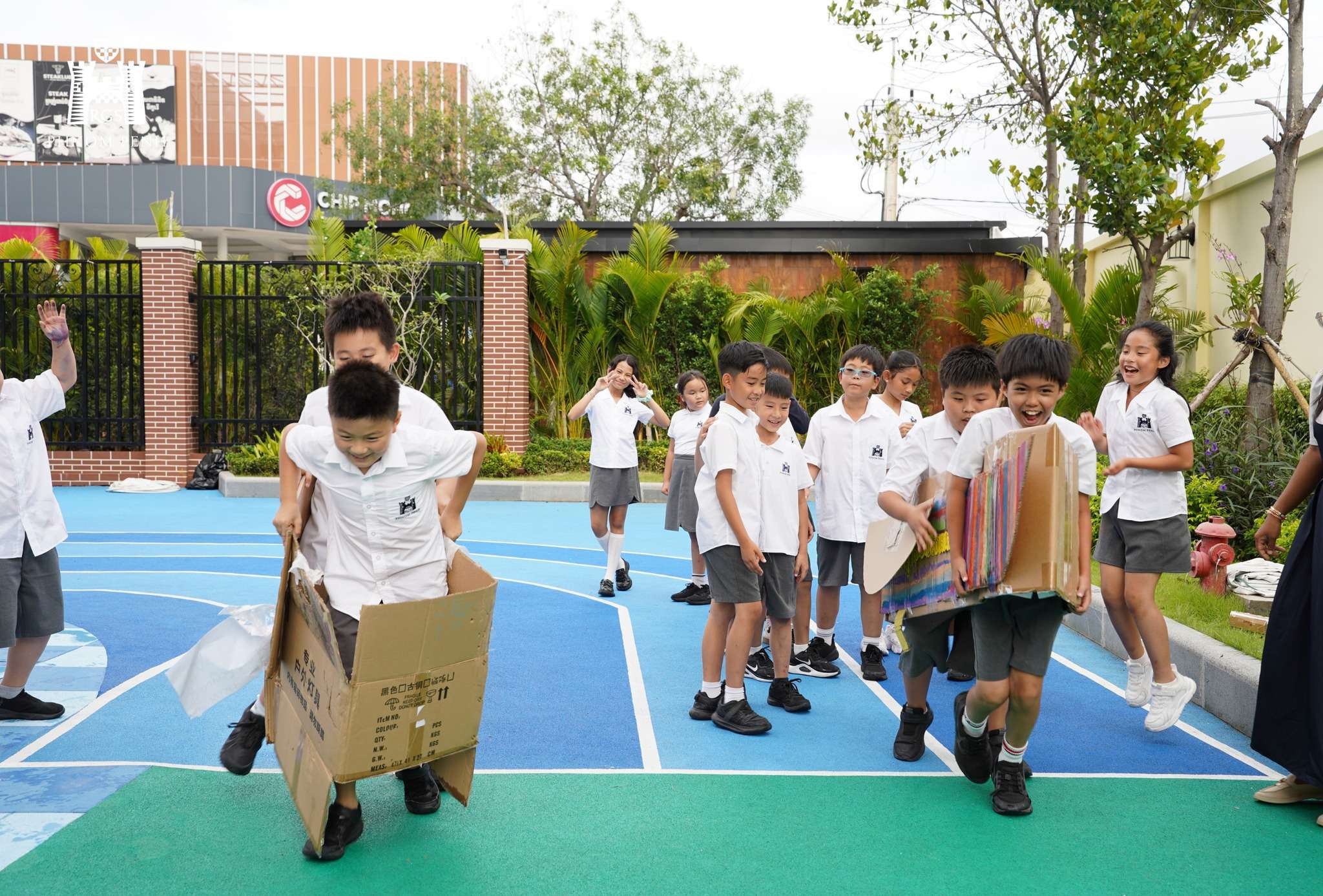 Students from Reigate Grammar School Phnom Penh participating in a creative cardboard boat racing activity