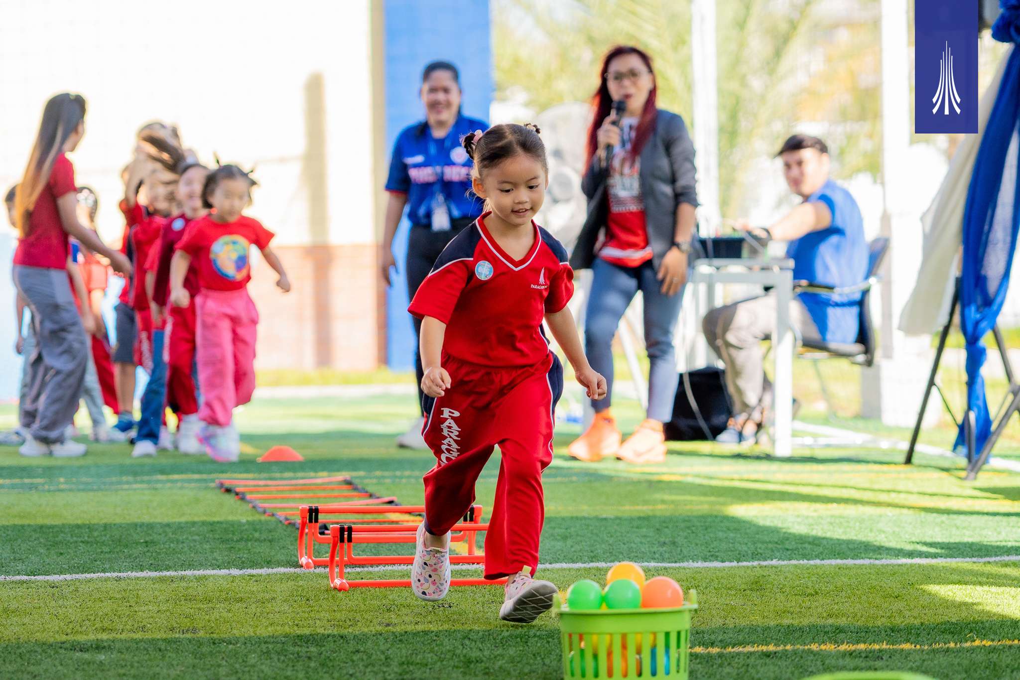 Children and parents participating in Paragon International School’s Family Sports Day with outdoor activities and teamwork-focused games.