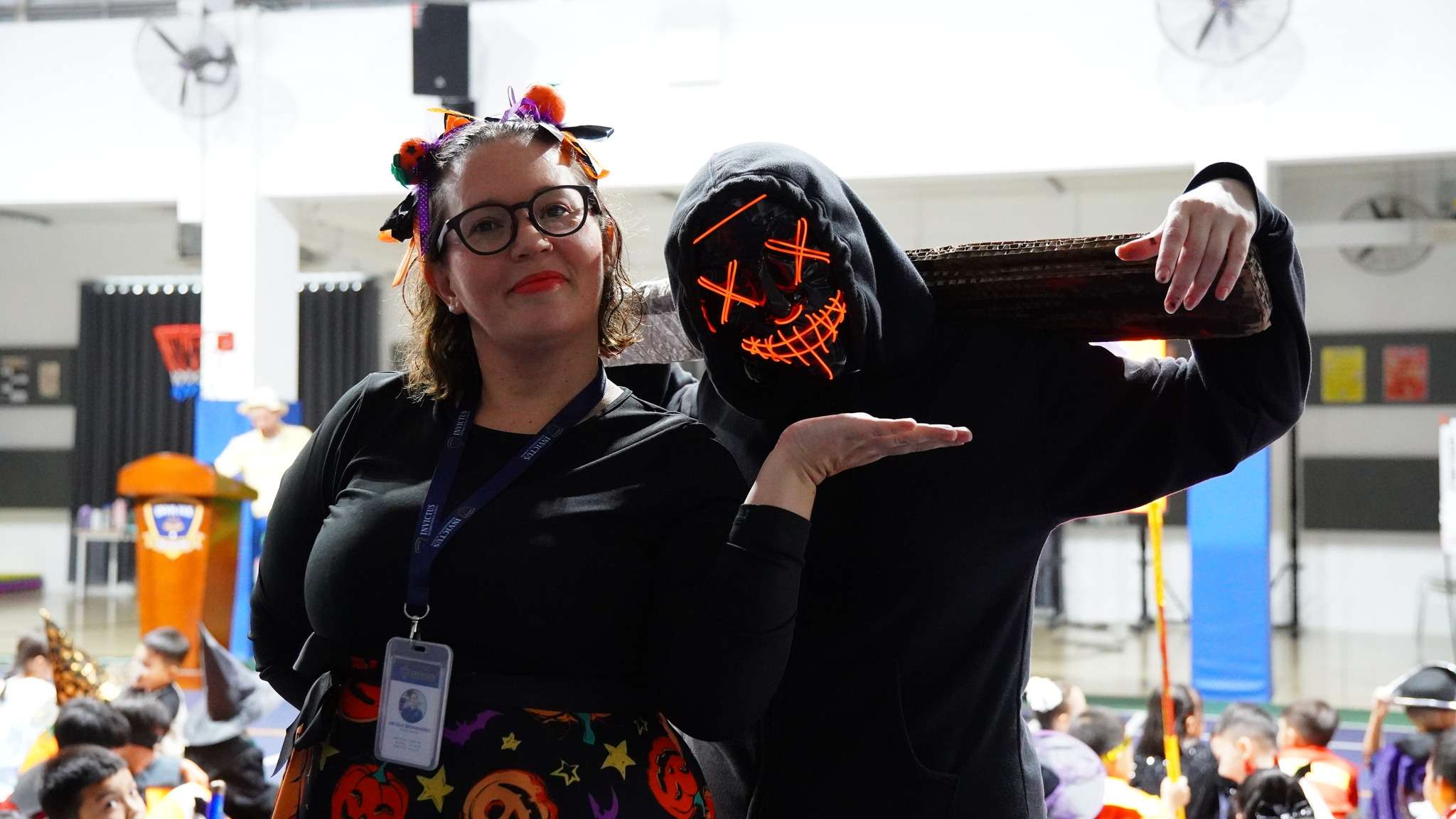 Students at Invictus International School Phnom Penh dressed in Halloween costumes during a school parade and group celebration.