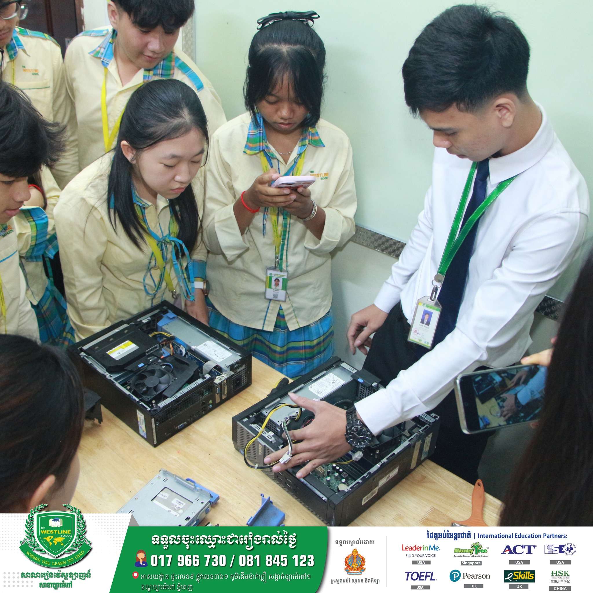 Students at The Westline School, Chbar Ampov Branch participating in a hands-on computer hardware activity in a classroom