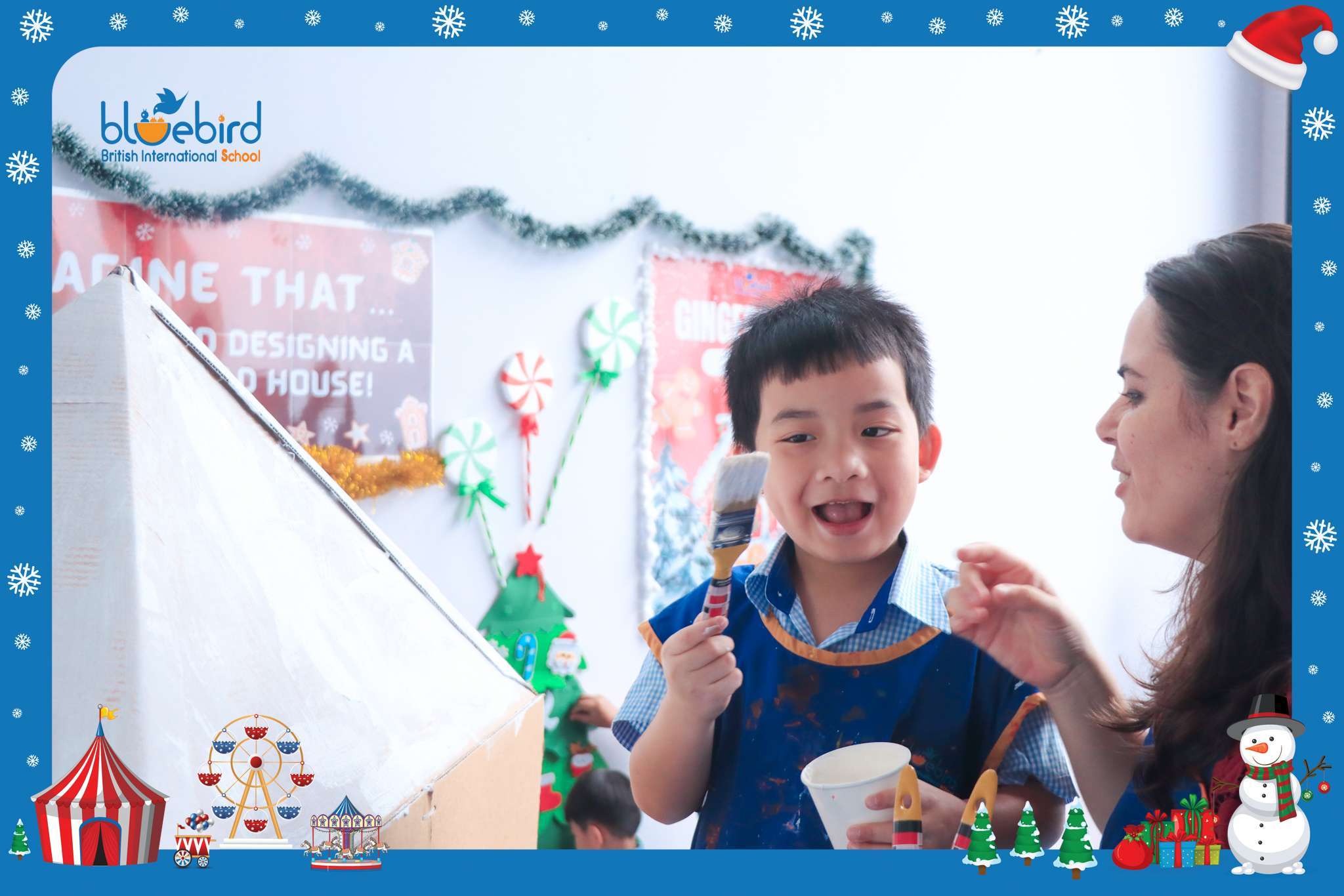 Early Years students at Bluebird British International School painting and decorating a festive gingerbread house project.