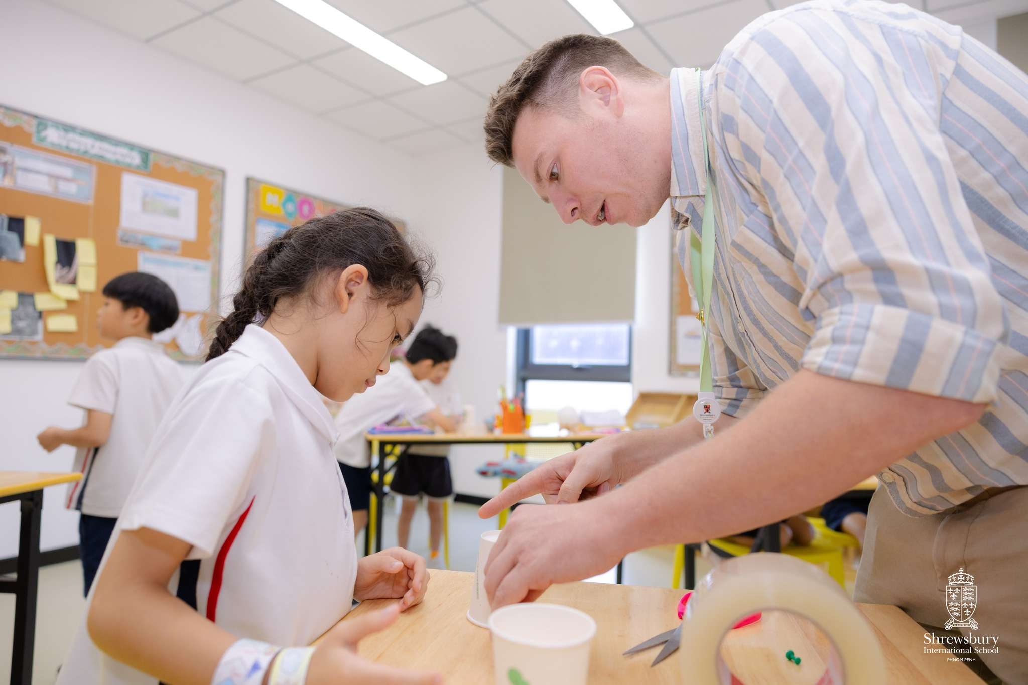 Students at Shrewsbury International School Phnom Penh building and testing homemade anemometers during a hands-on weather science activity.