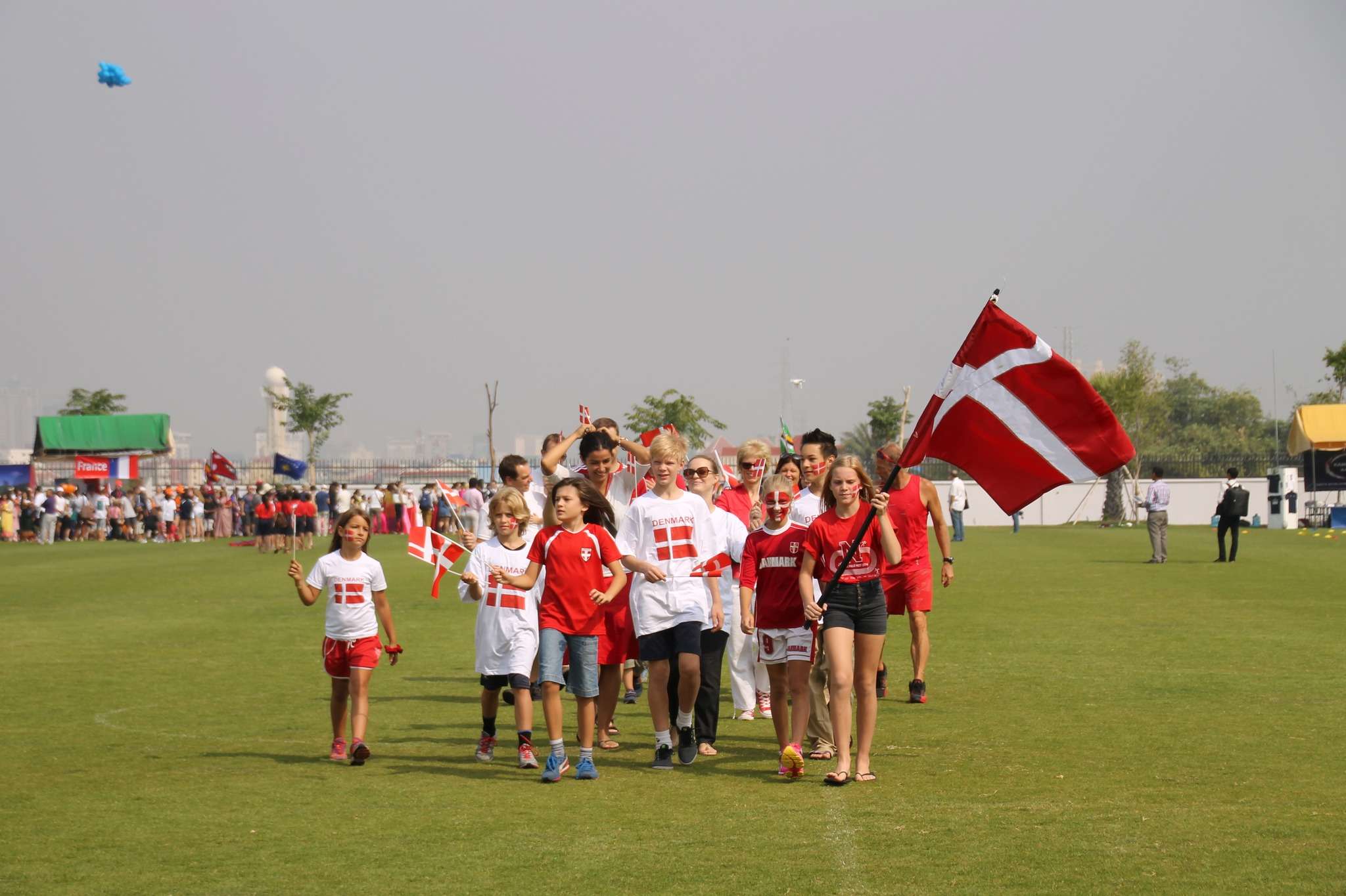 Students, teachers, and families participating in past ISPP International Day celebrations with cultural booths, performances, and outdoor activities.