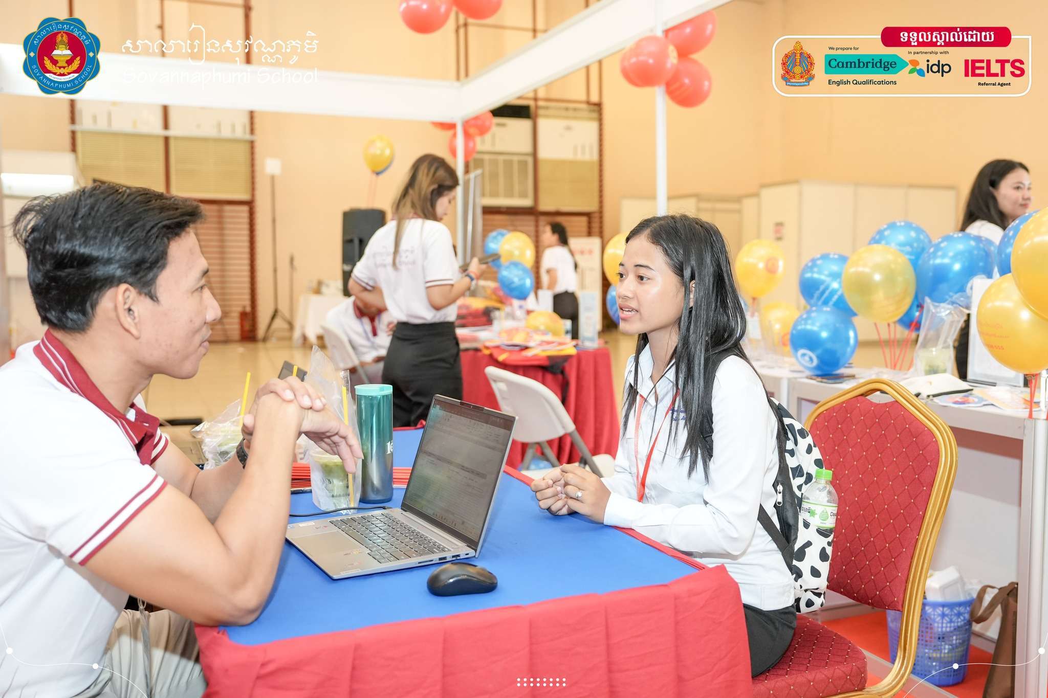 Students and representatives from Sovannaphumi School engaging with visitors at their National Career Fair 2025 booth