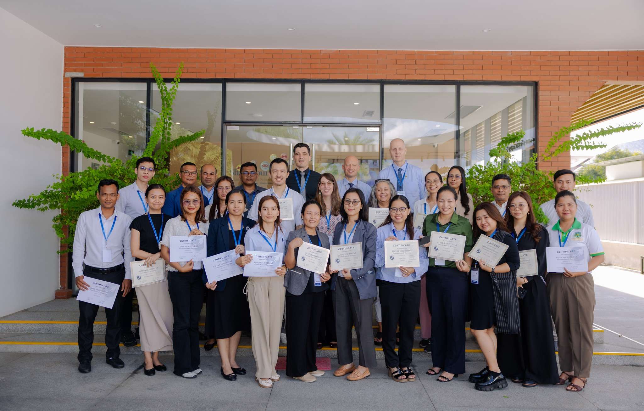 Group photo of school leaders and HR staff holding certificates after safeguarding training at Shrewsbury International School Phnom Penh