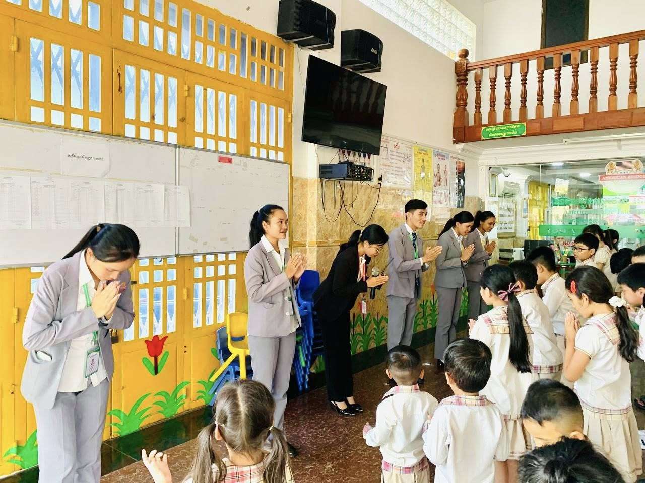 Teachers and students at American Bridge International School participating in a classroom sharing activity.