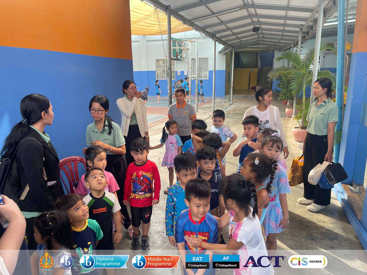 Students from Golden Gate American School participating in a swimming field trip, lining up, preparing for water activities, and engaging in outdoor learning.
