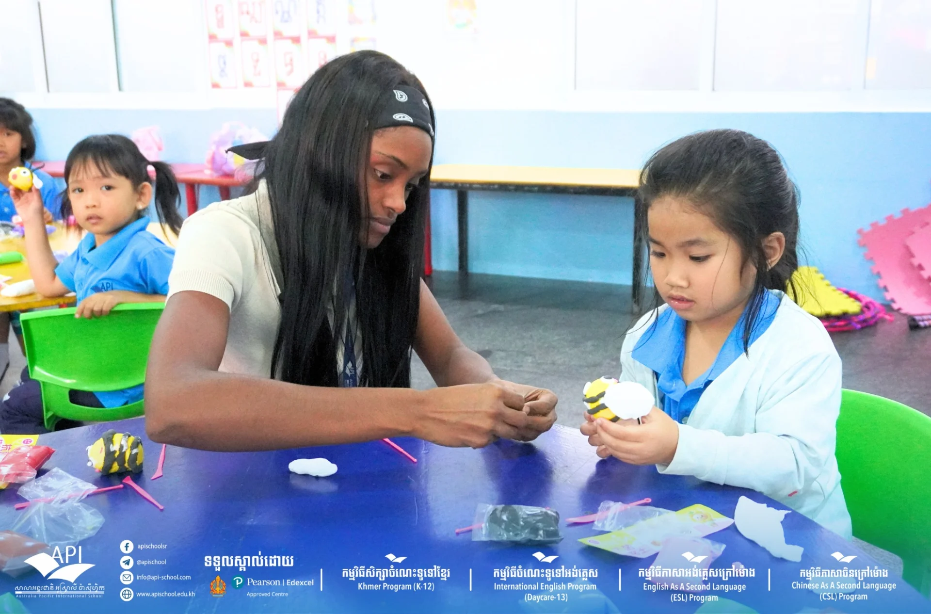 Kindergarten students at API School creating colorful bee crafts during a hands-on early years classroom activity in Cambodia