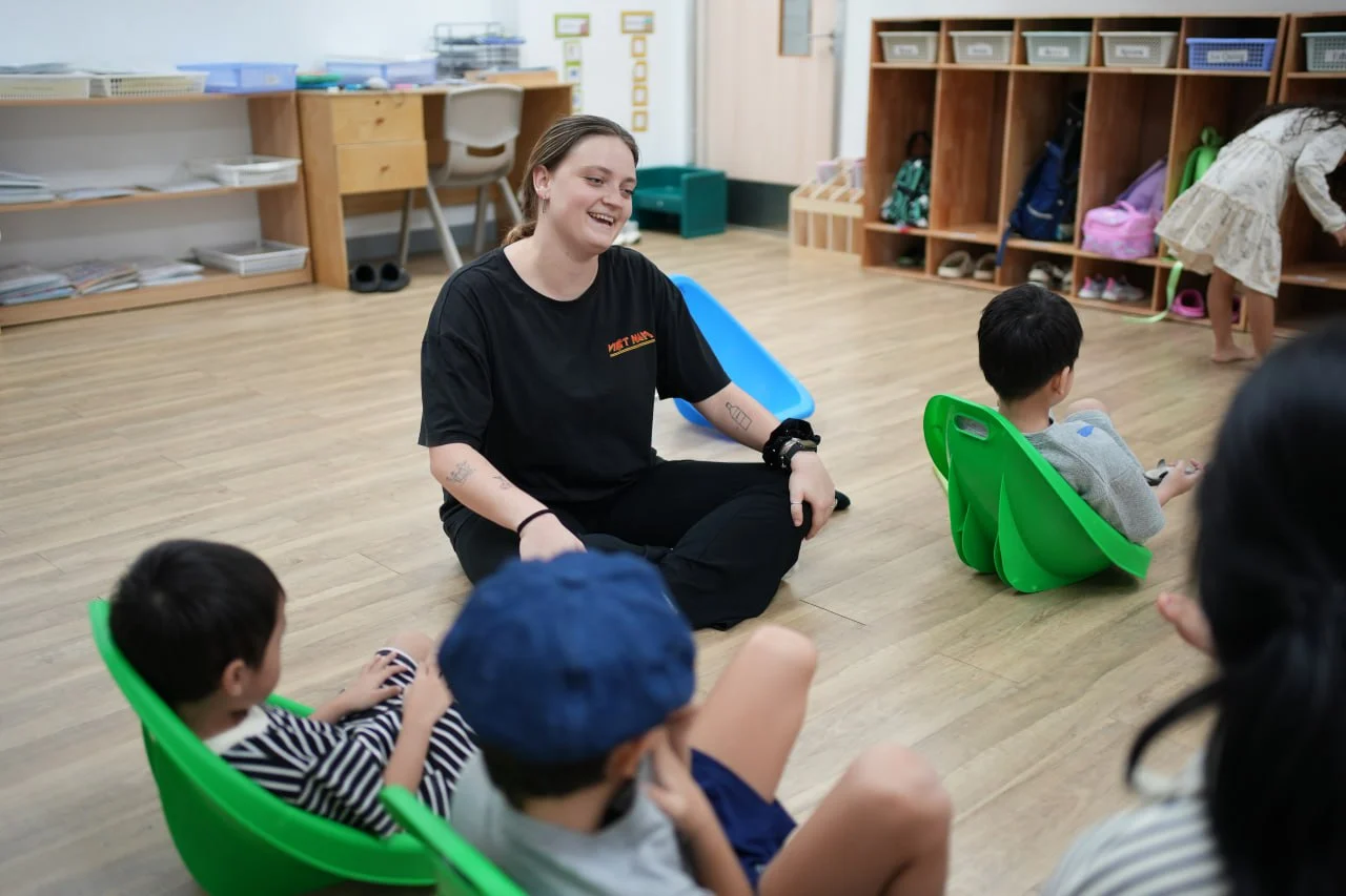 Children engaged in play-based learning activities with teachers and therapists at OrbRom Preschool in Phnom Penh