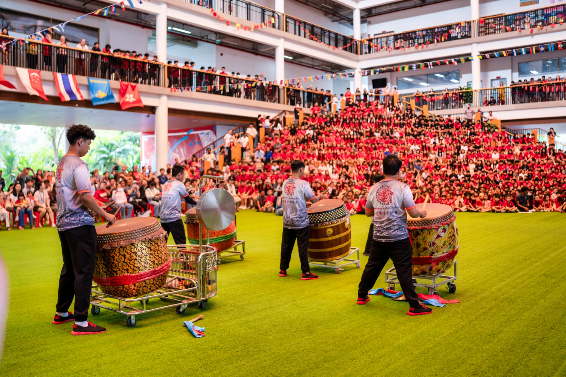 Students and performers celebrating Lunar New Year with a traditional dragon dance at Canadian International School of Phnom Penh