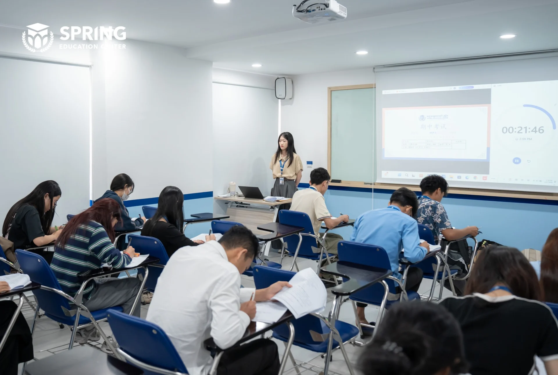Students completing a midterm examination in a structured classroom at Spring Education Center