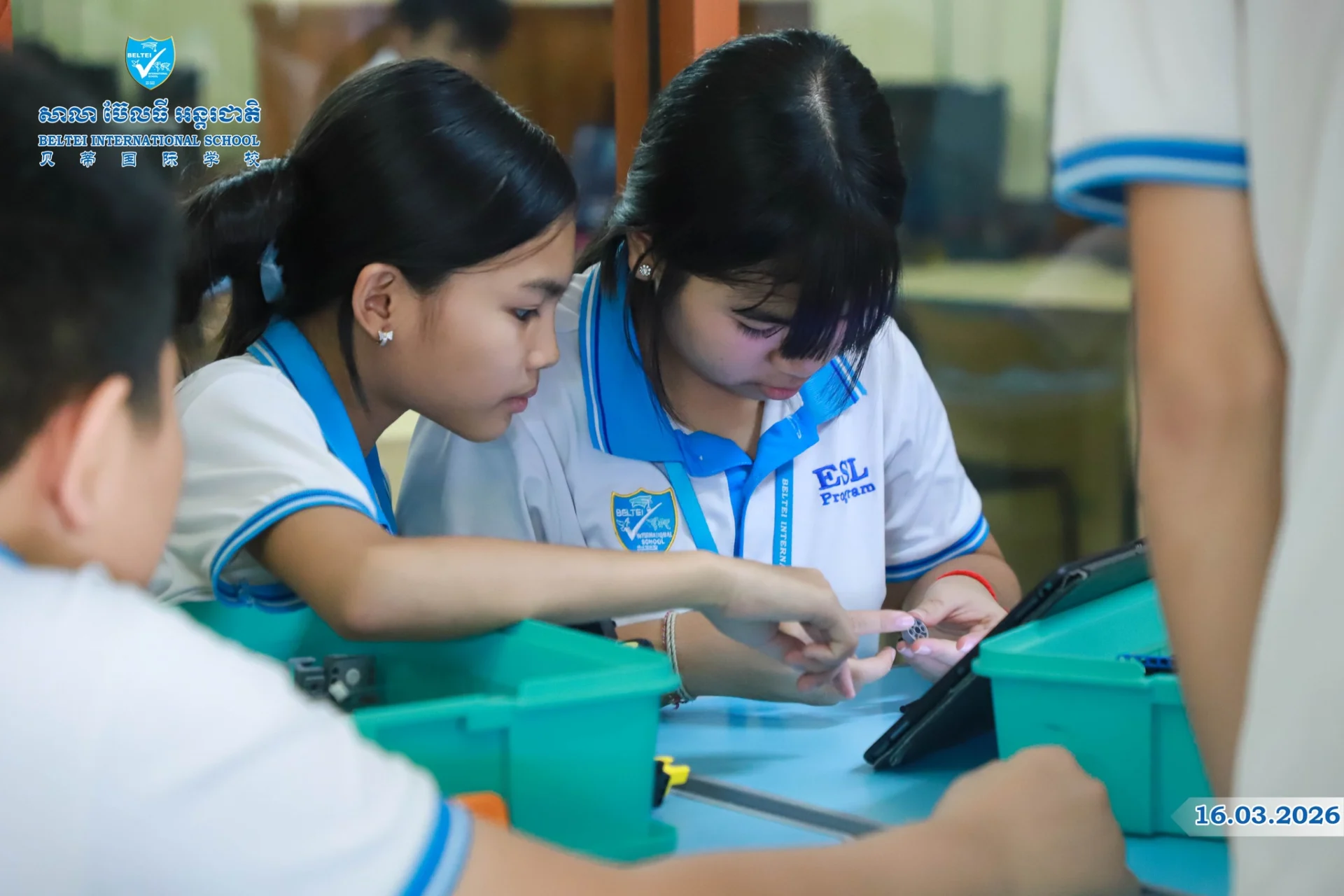 Students at BELTEI International School participating in robotics and STEAM learning activities with teachers in a classroom setting.