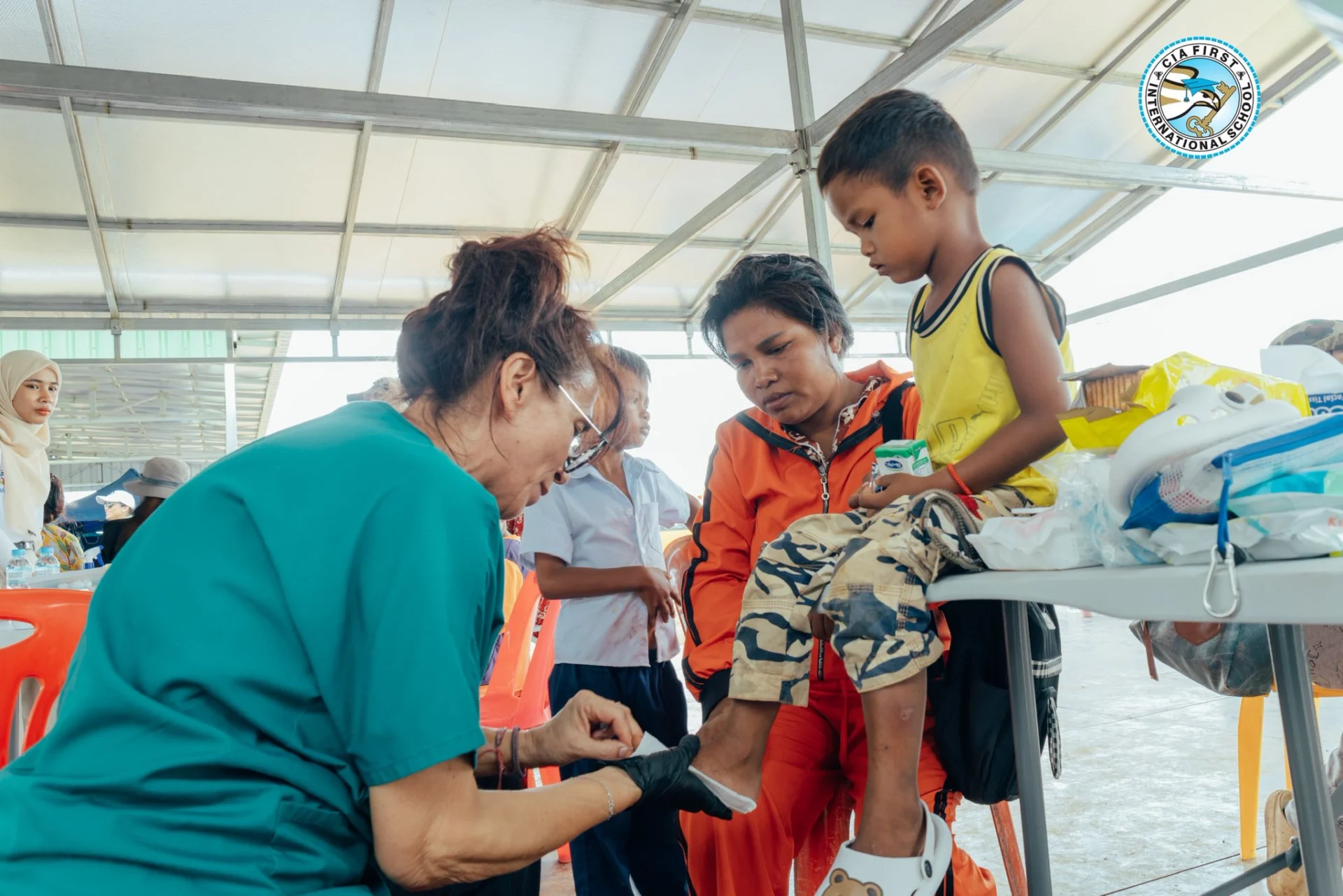 CIA FIRST International School community members participating in a medical outreach mission providing healthcare support to Cambodian families near the border.
