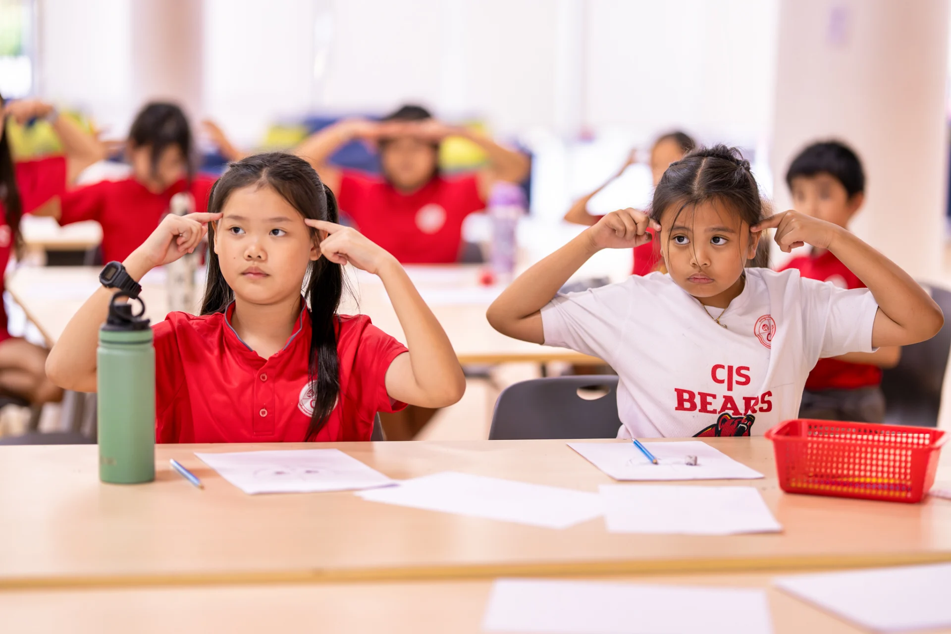 Students at Canadian International School of Phnom Penh participating in Book Week illustration workshop with professional artist