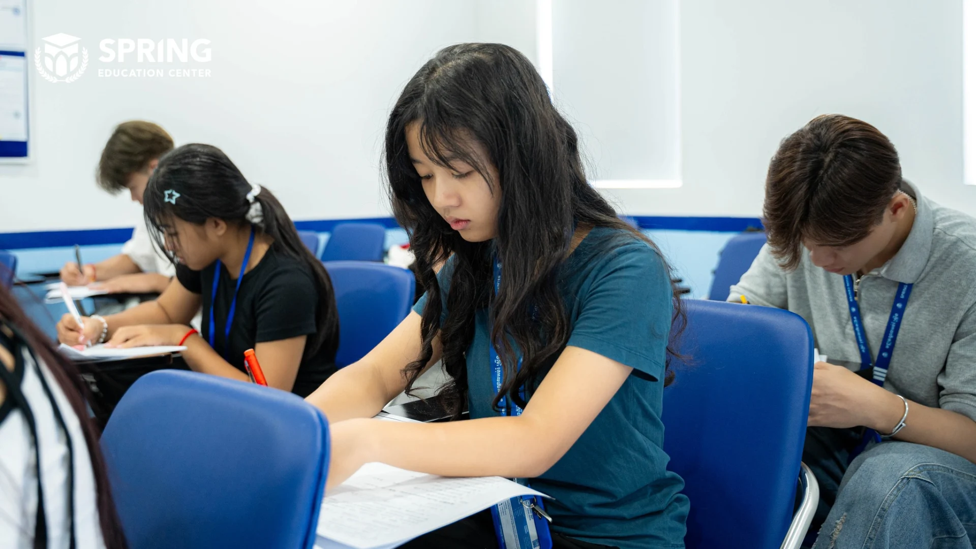 Students taking final exams at Spring Education Center in a structured classroom environment